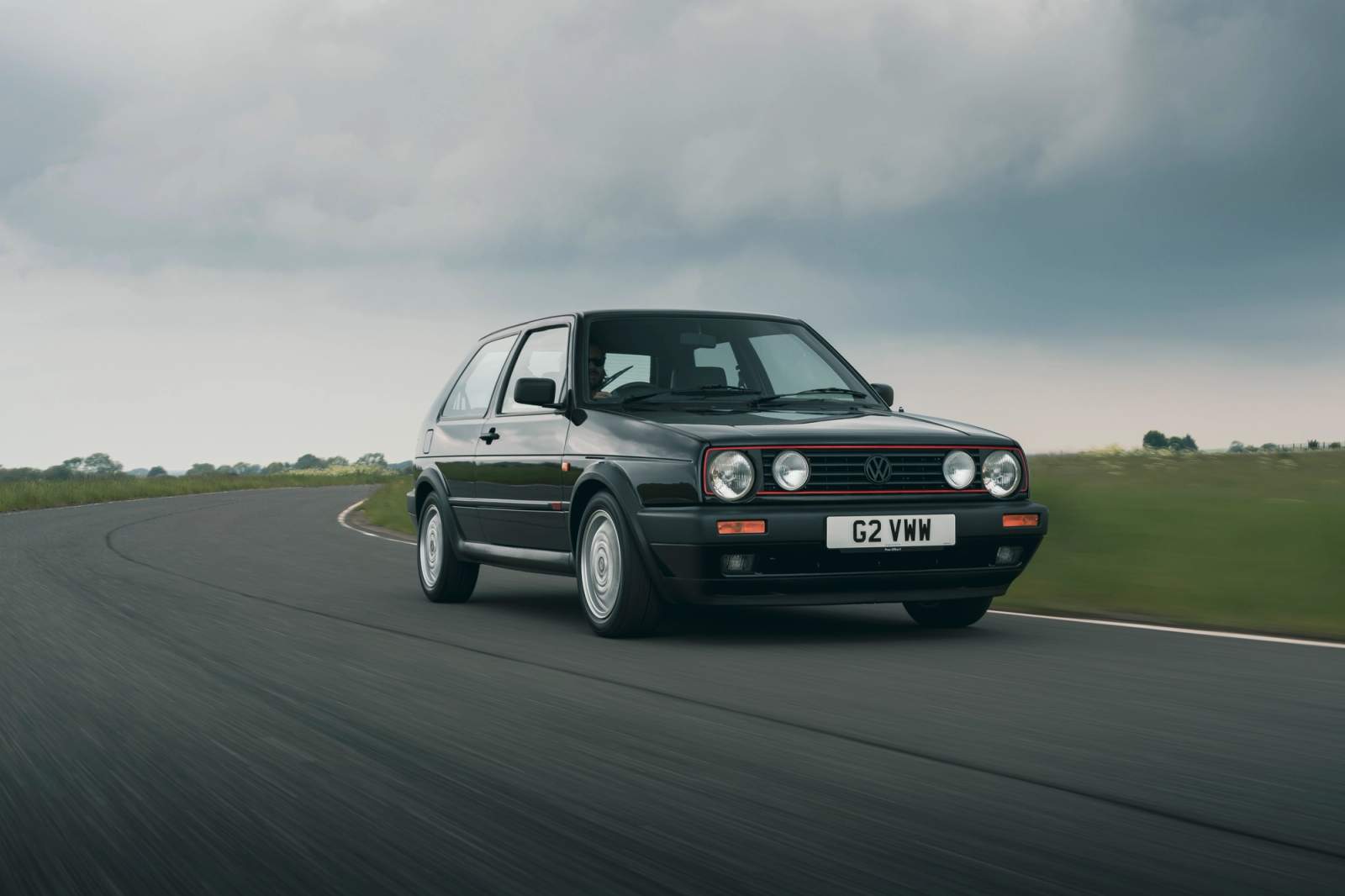 Black Volkswagen Golf GTI driving