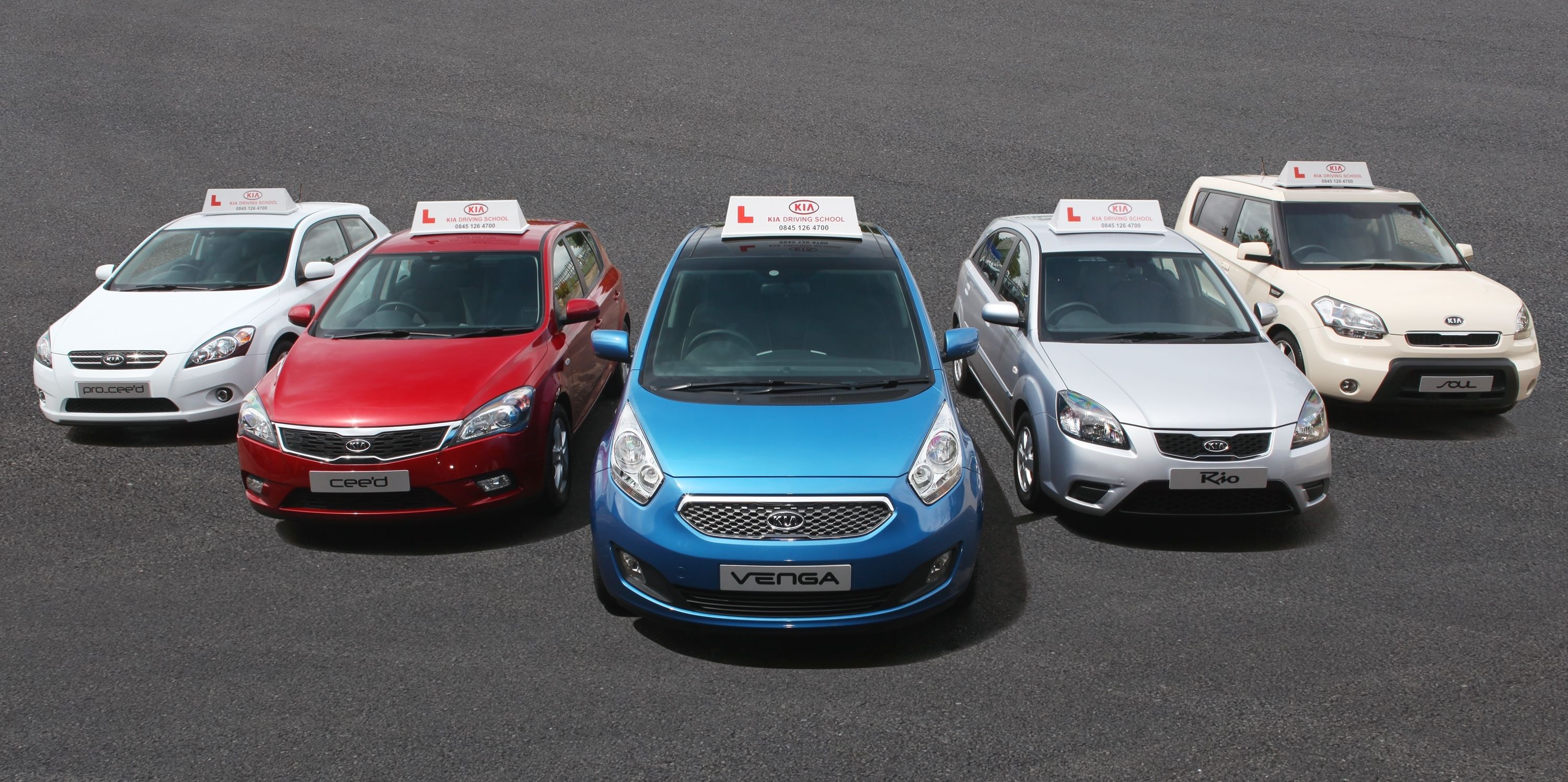Row of Kia driving instructor vehicles