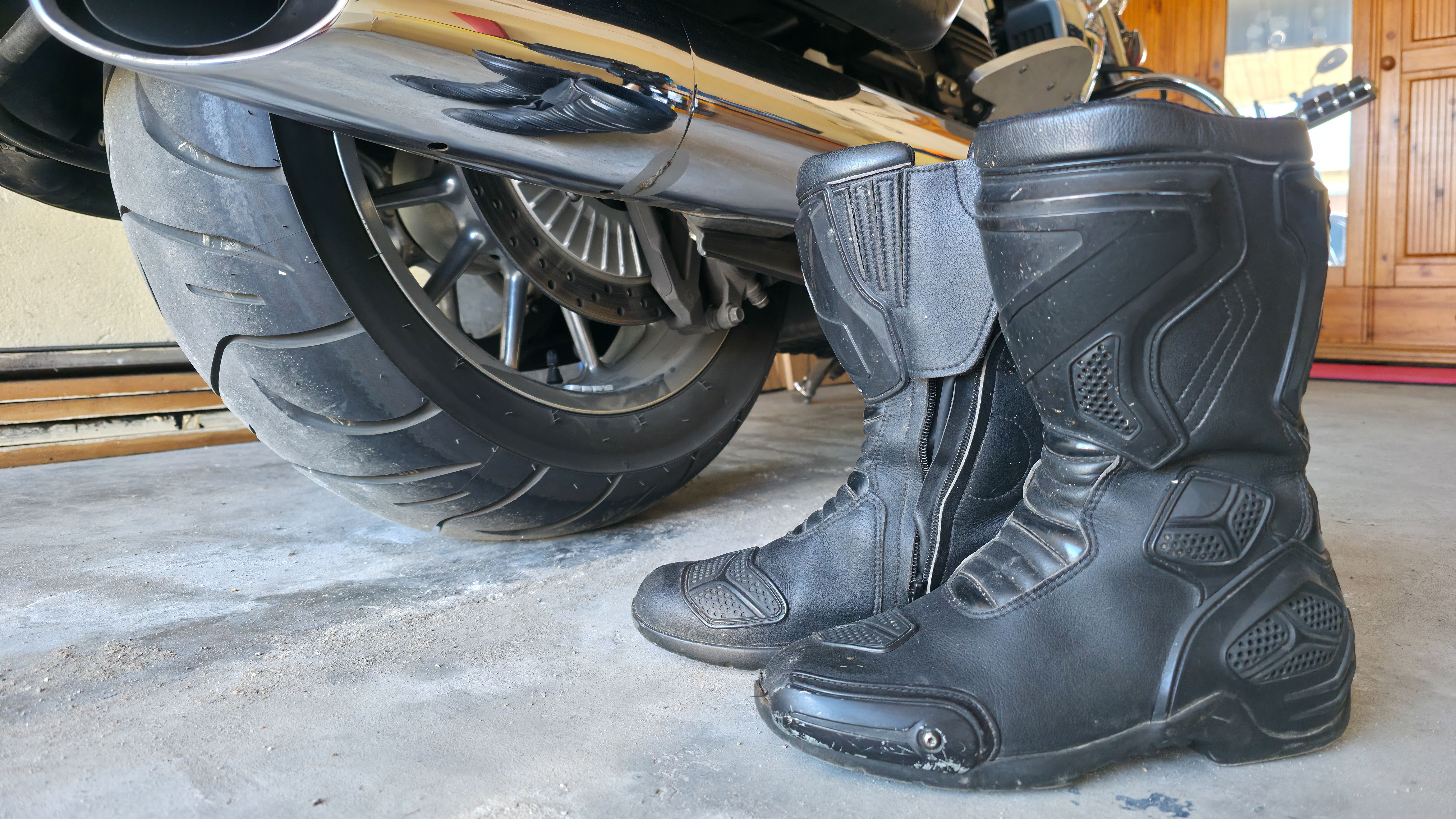 Motorbike boots next to bike