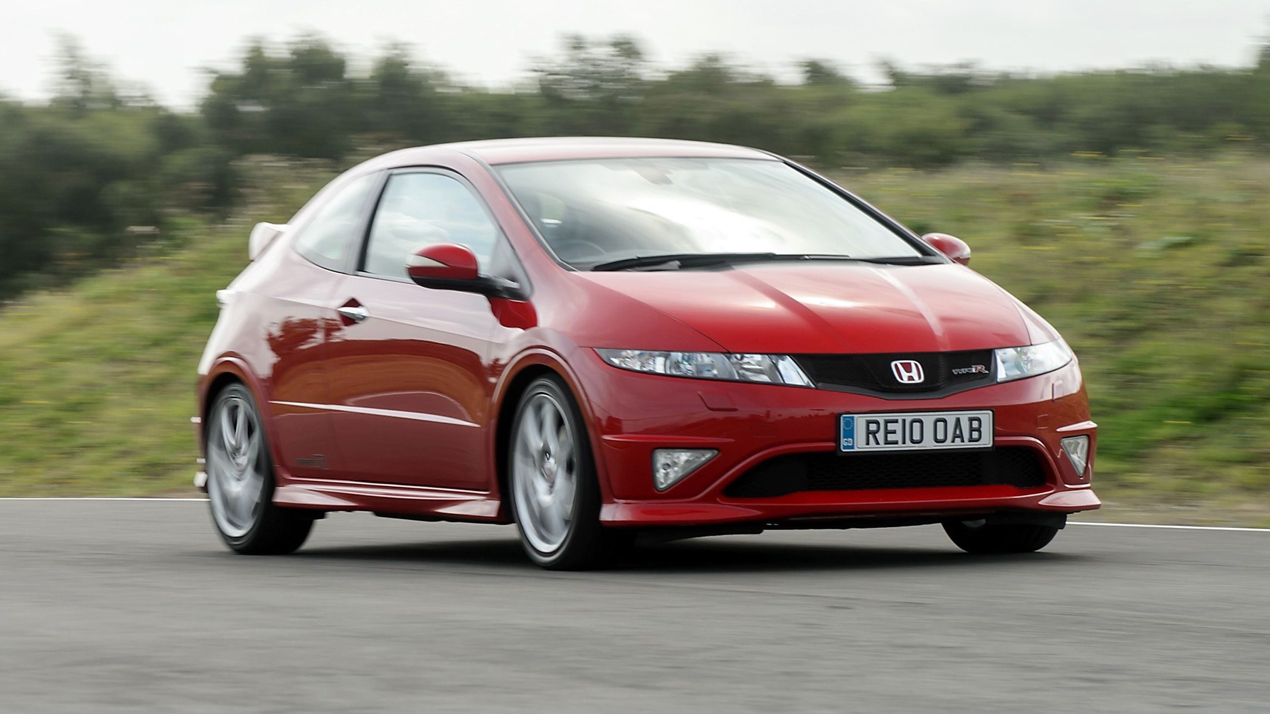 Red Honda Civic Type R driving around a circuit