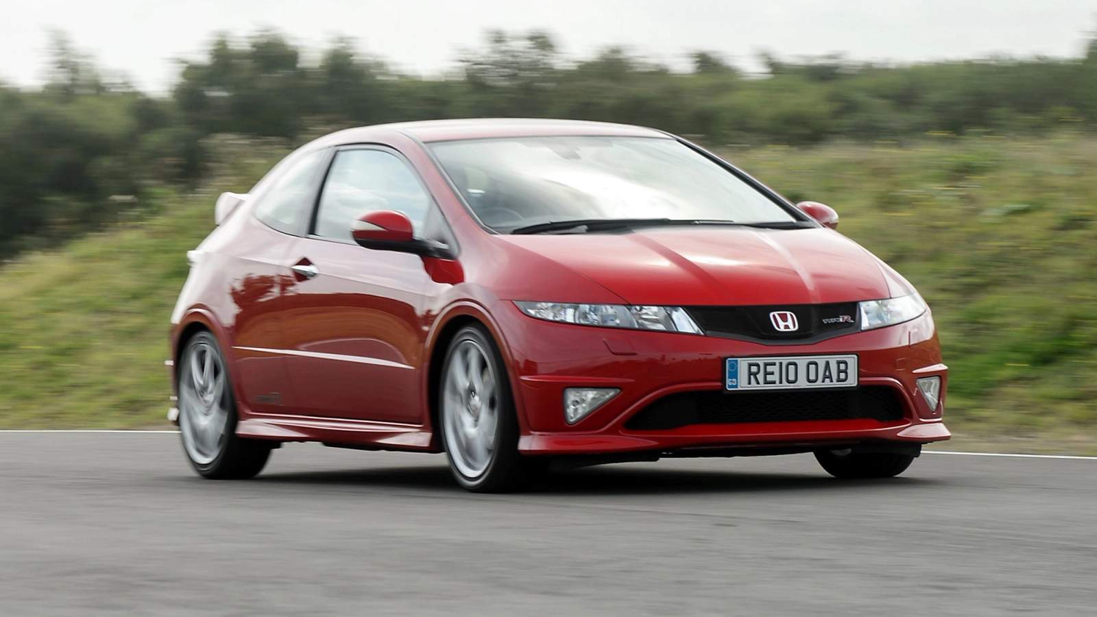Red Honda Civic Type R driving around a circuit