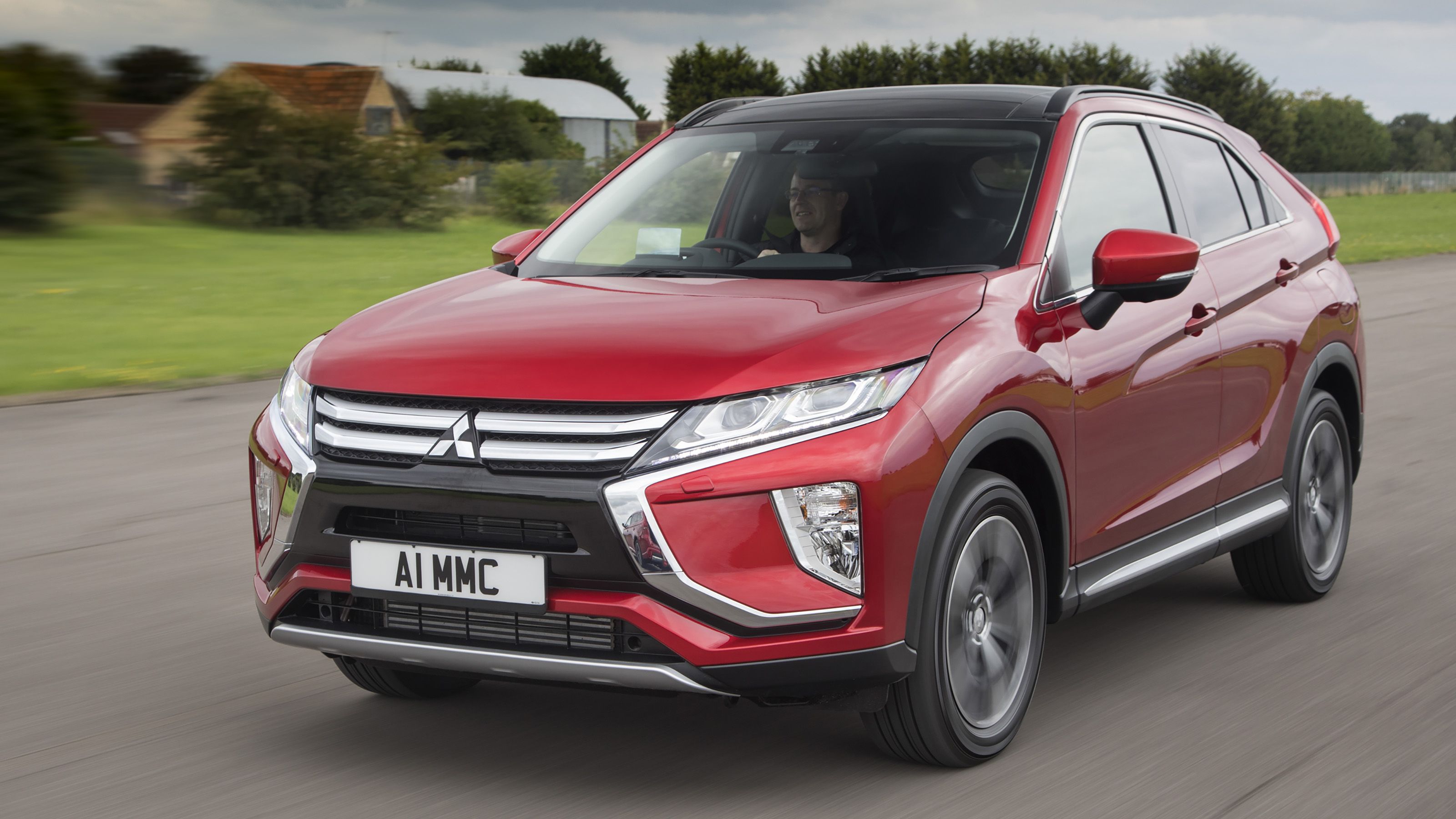 Red Mitsubishi Eclipse Cross front driving