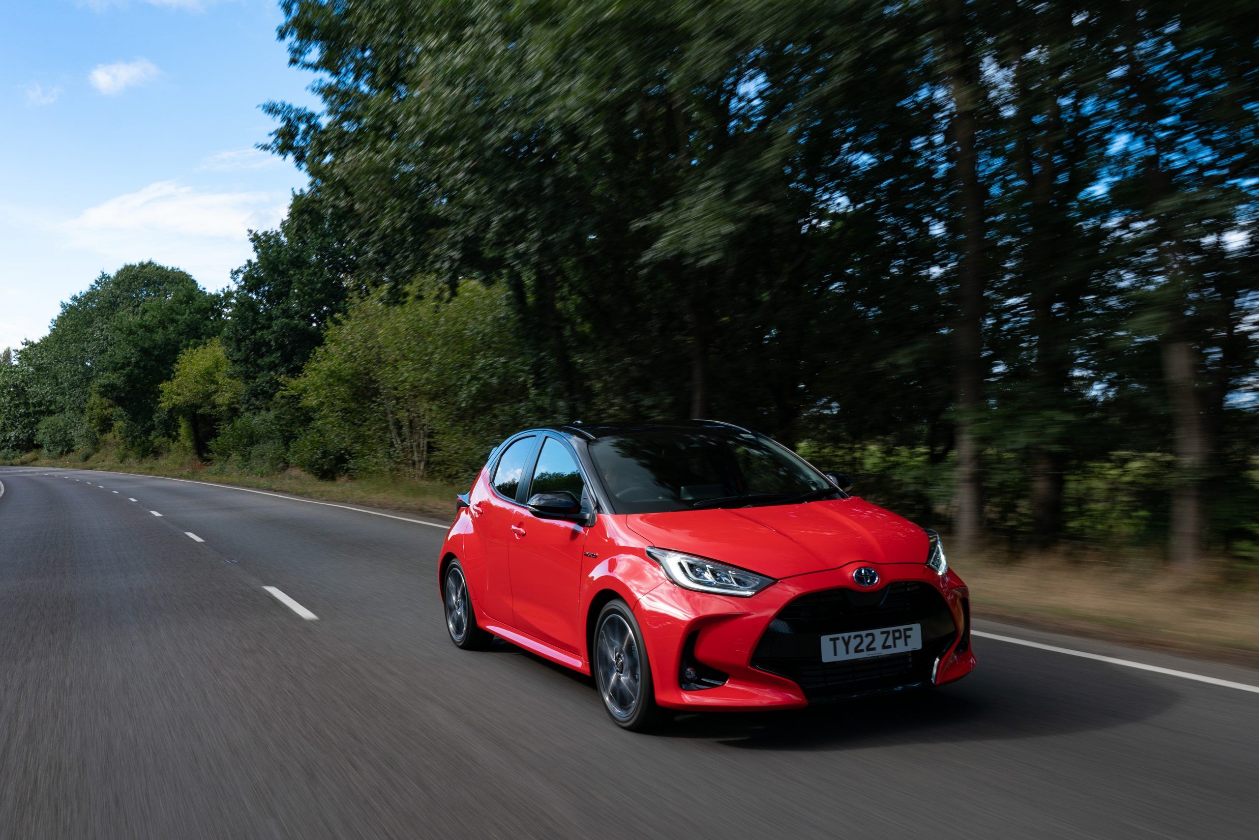 Red Toyota Yaris driving