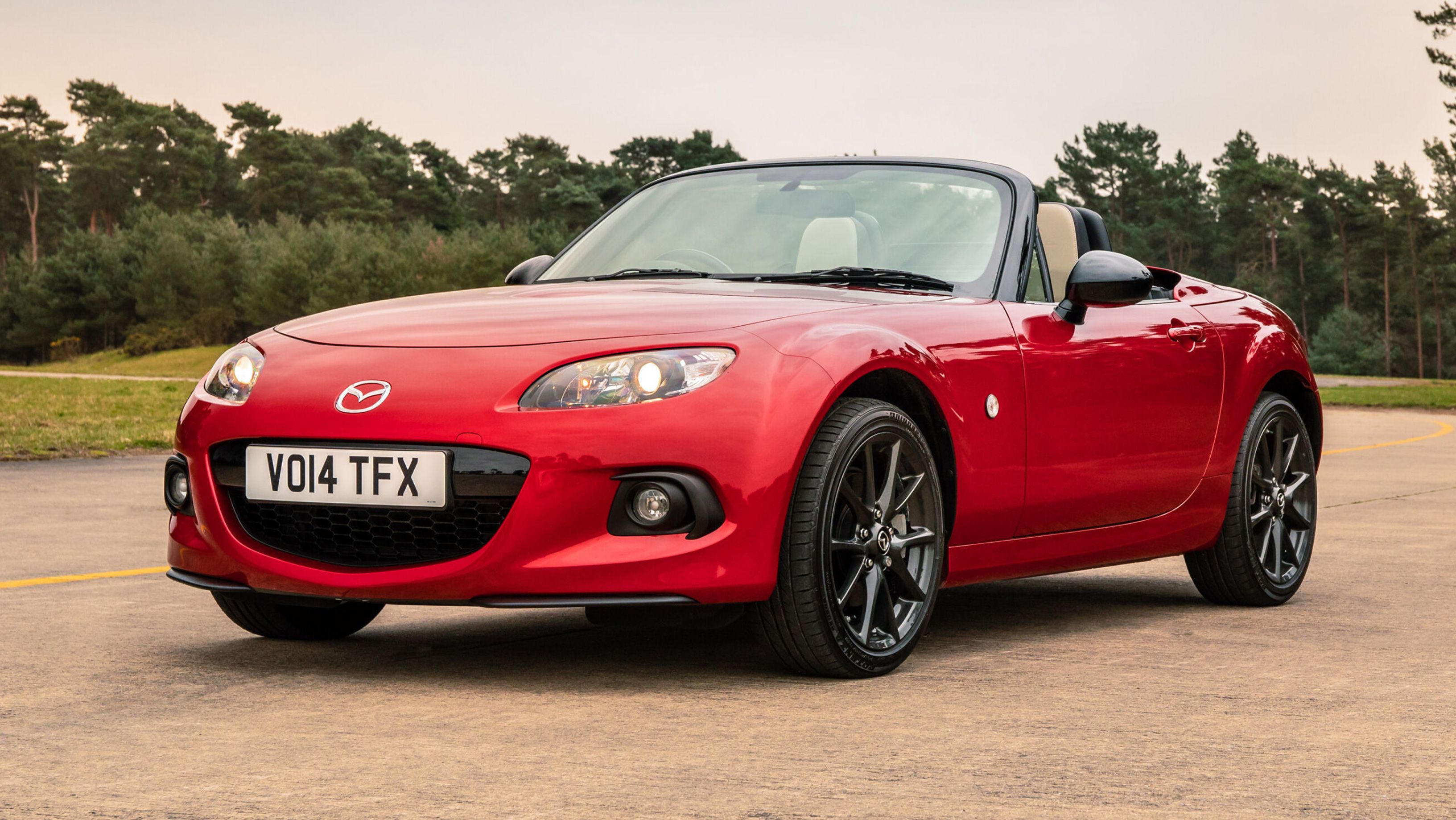 Red Mazda MX-5 parked on a runway