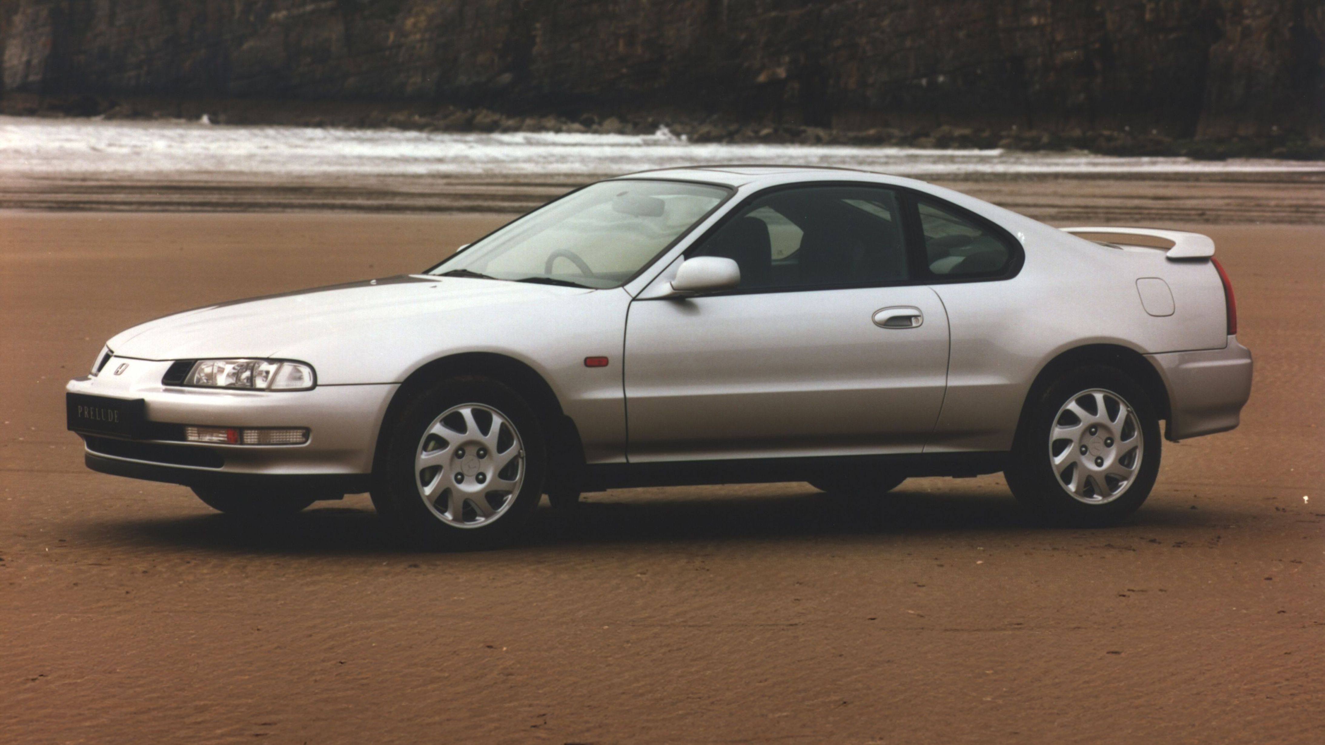Silver Honda Prelude on the beach