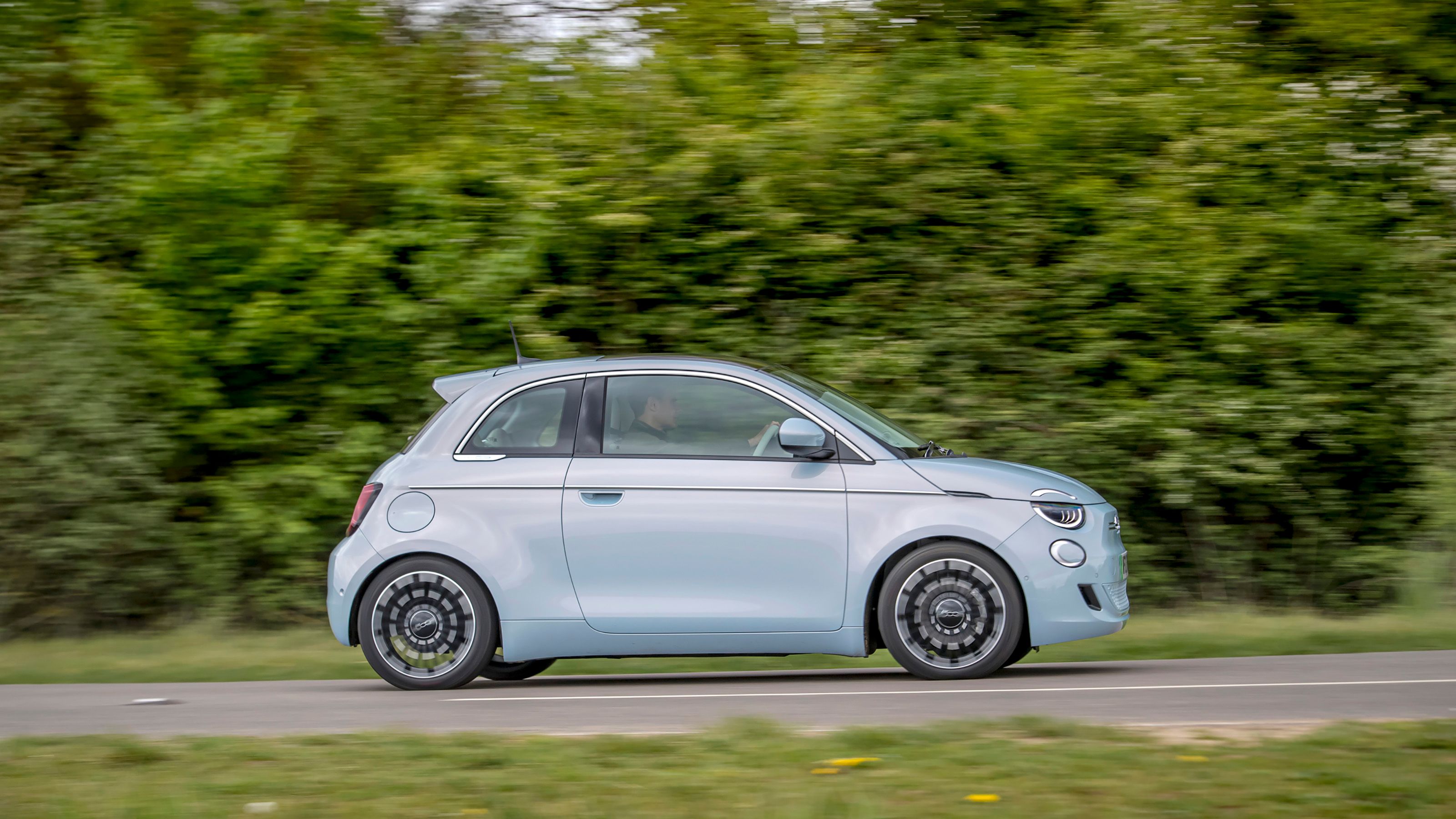 Blue Fiat 500e side driving