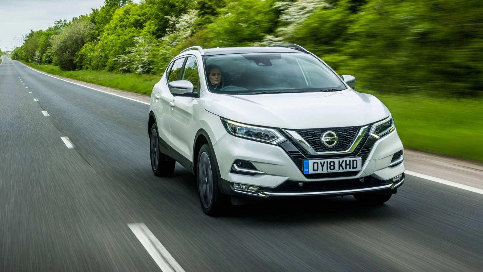 White Nissan Qashqai driving
