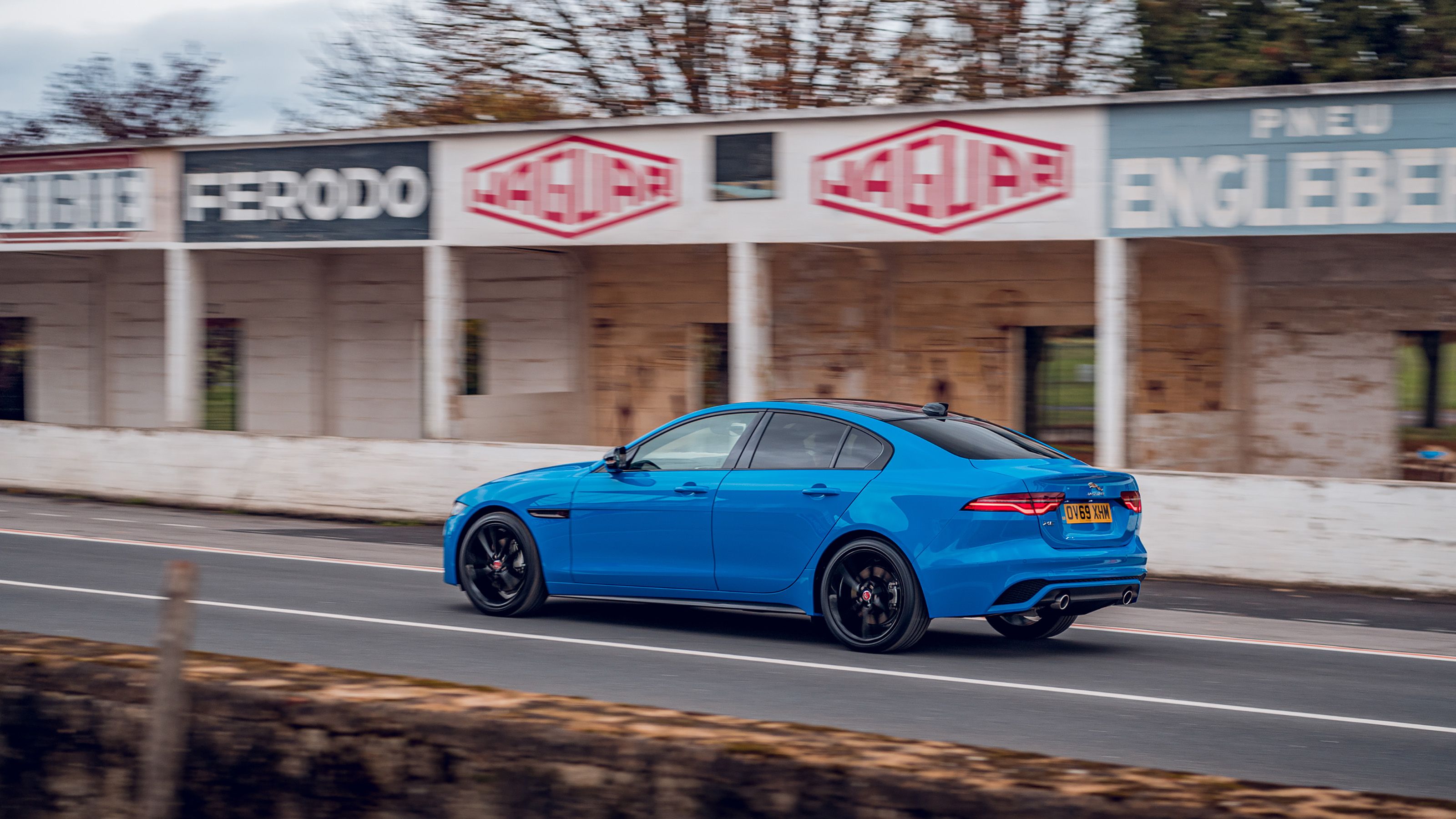 Blue Jaguar XE rear driving