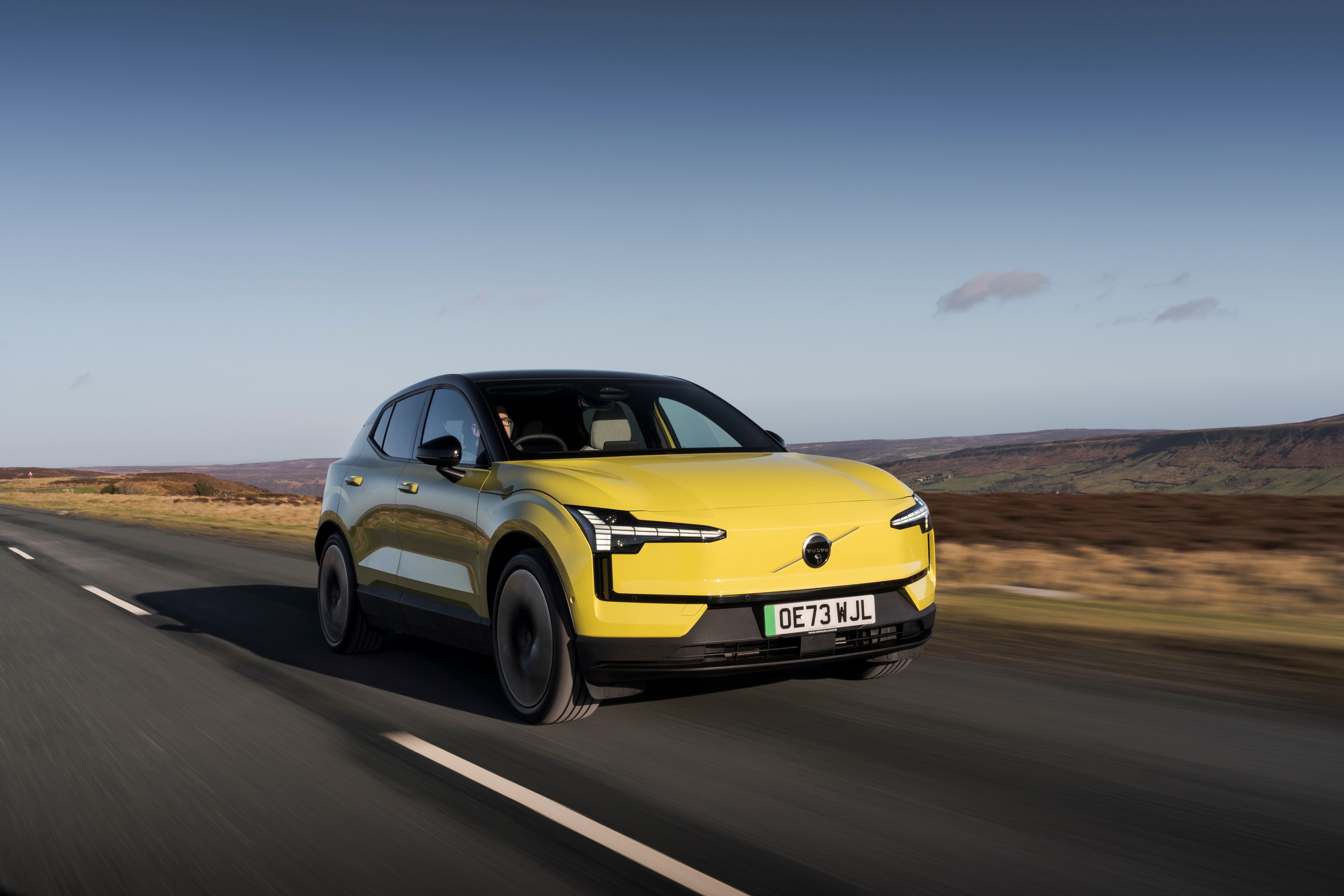 Yellow Volvo EX30 driving