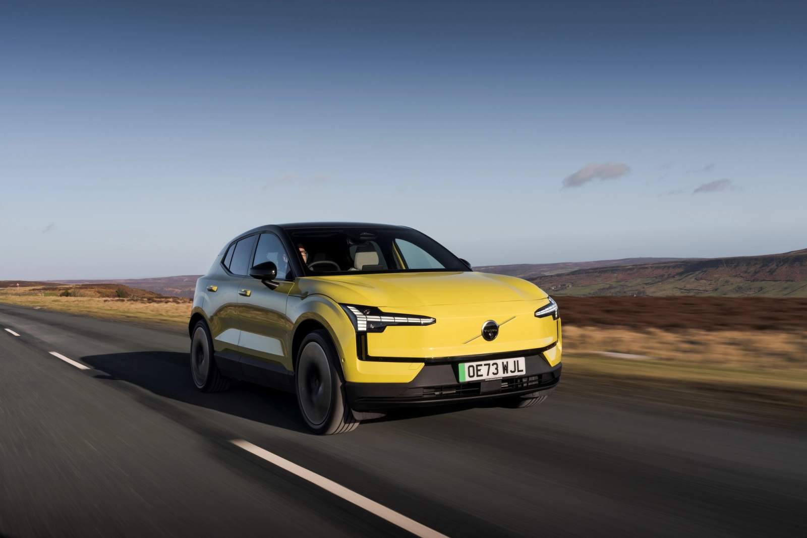 Yellow Volvo EX30 driving