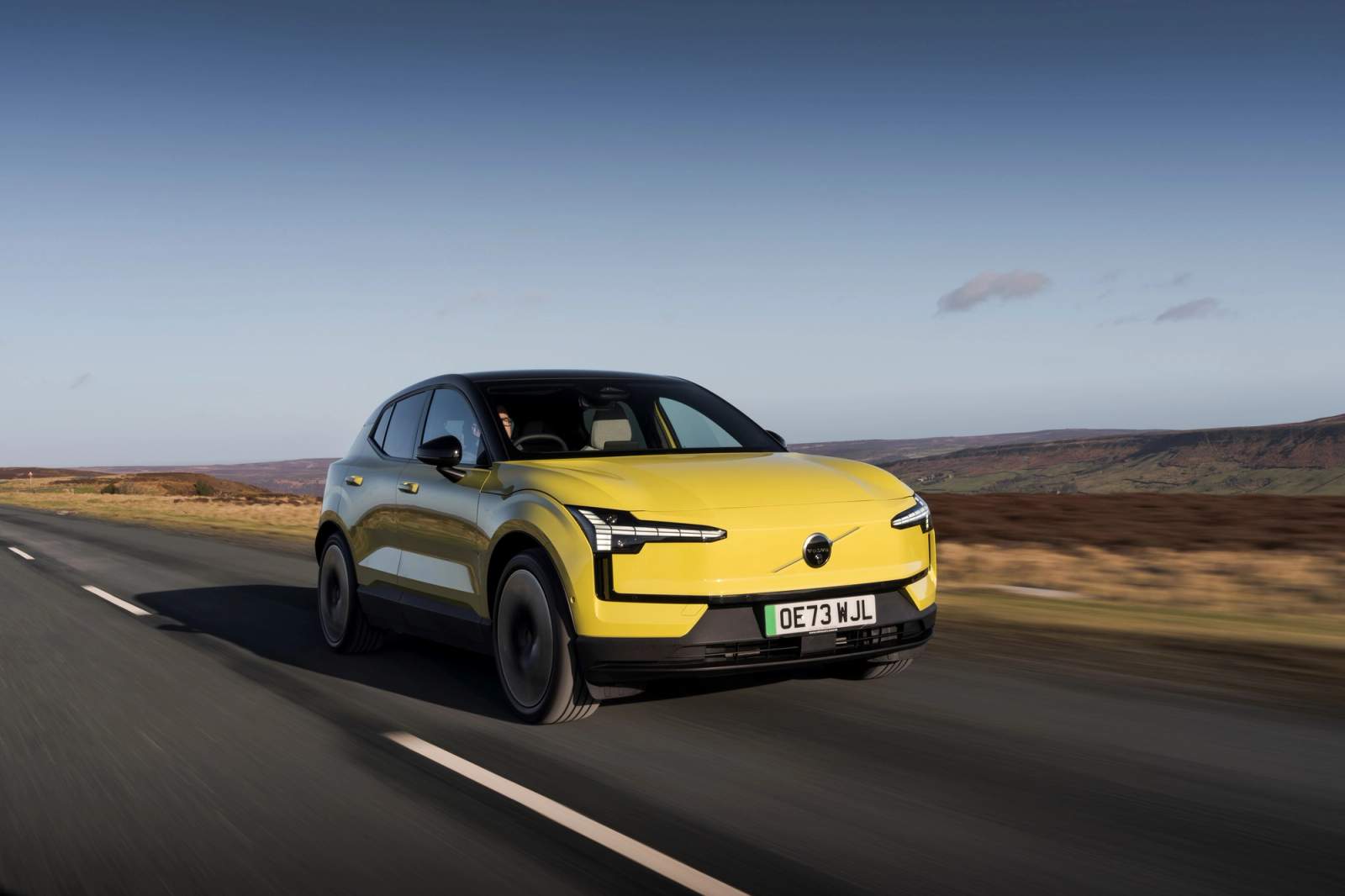 Yellow Volvo EX30 driving