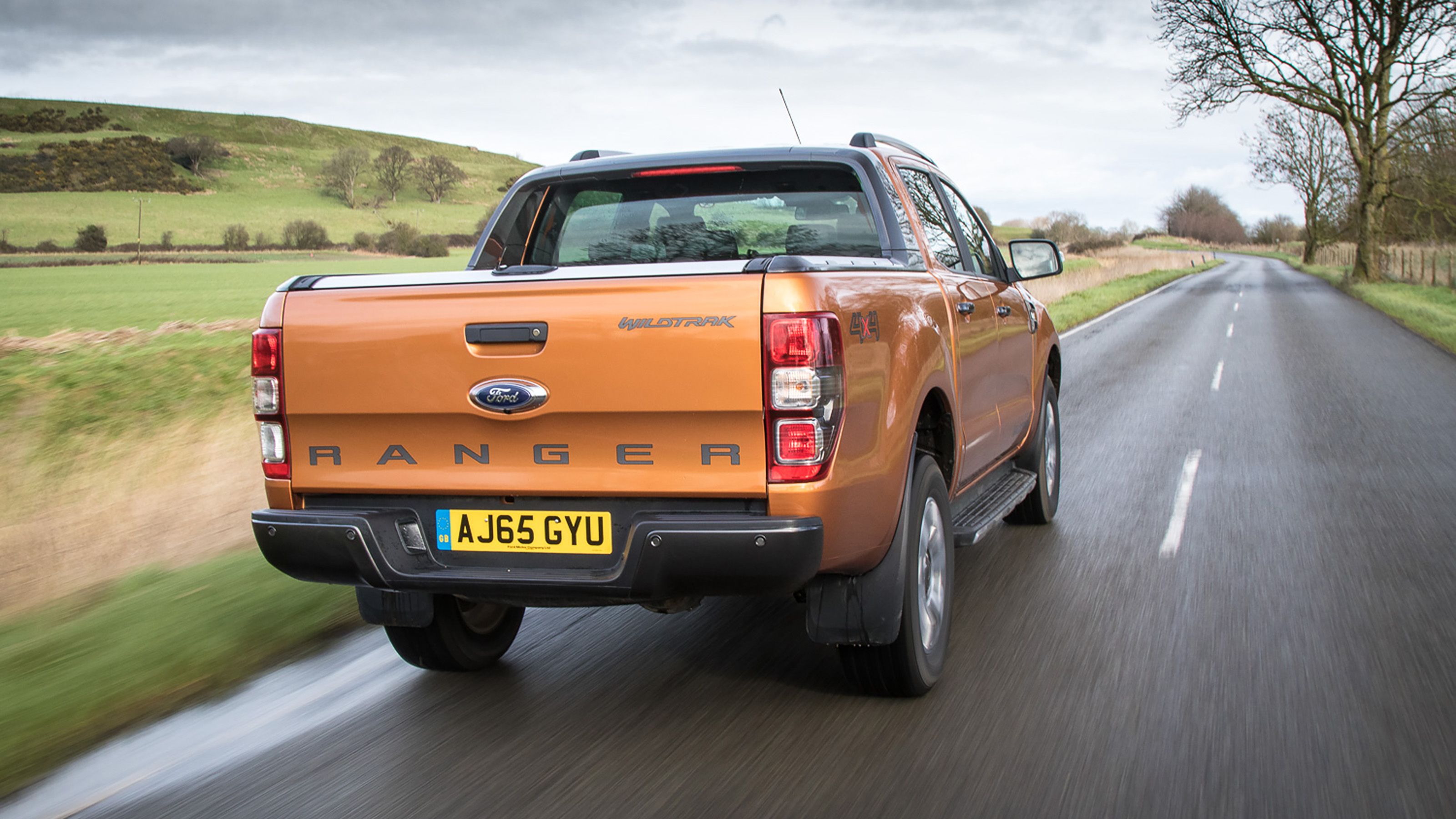 Orange Ford Ranger rear driving
