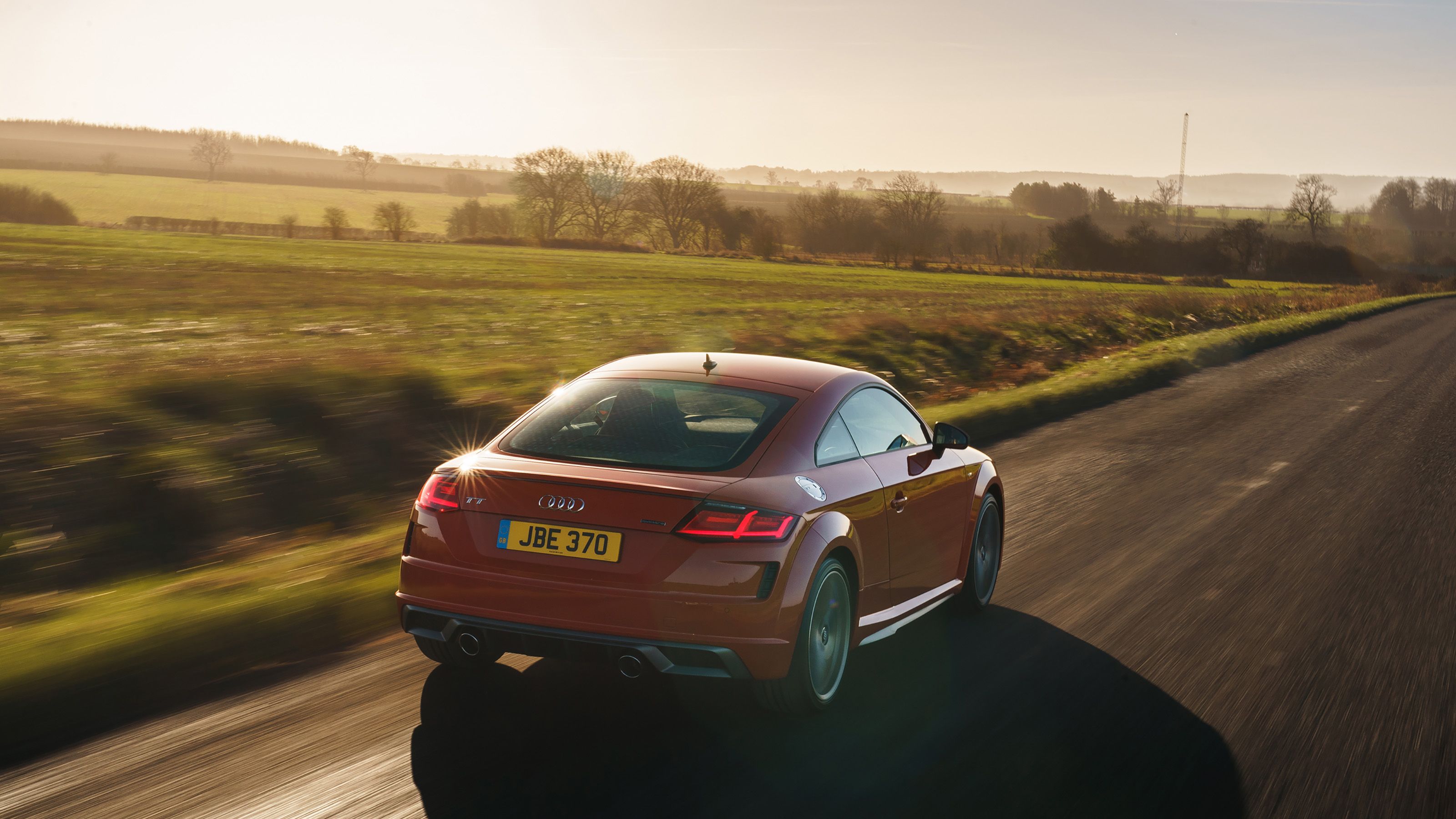 Orange Audi TT rear driving