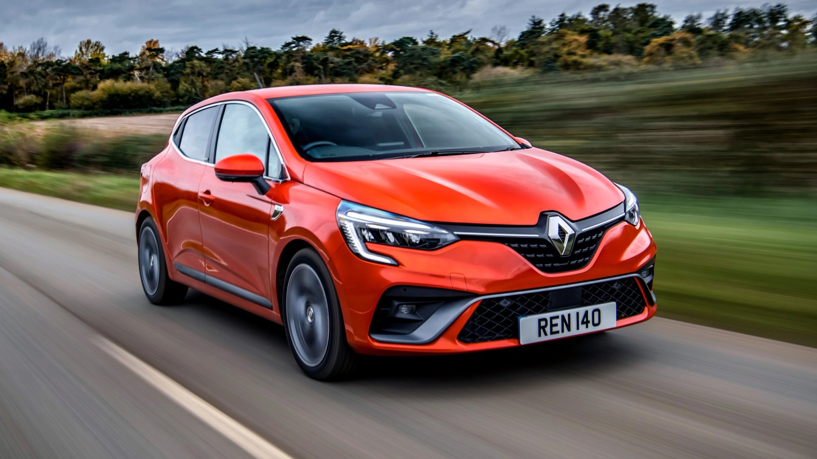 Orange Renault Clio front driving