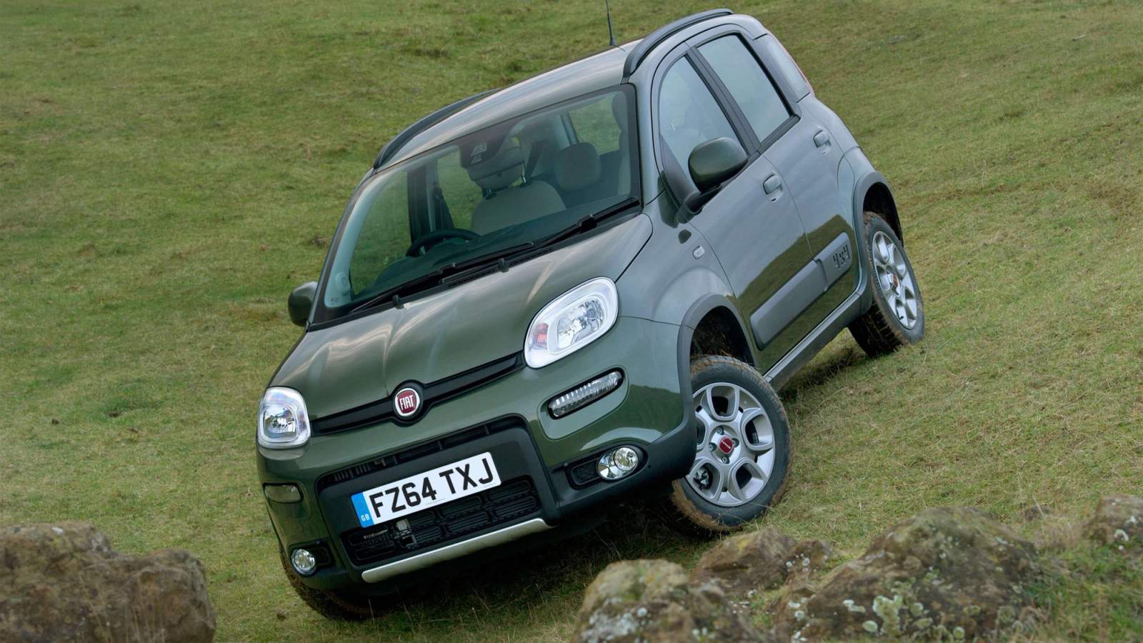 Green Fiat Panda 4x4 on a steep grassy hill