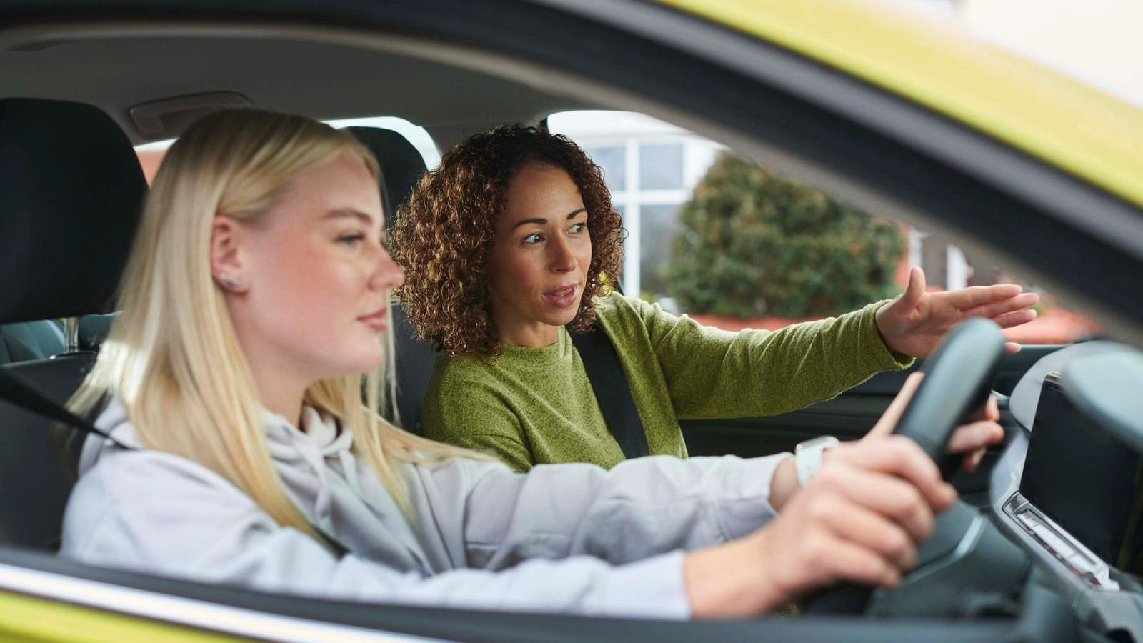 Provisional young driver and supervisor sitting in a car 