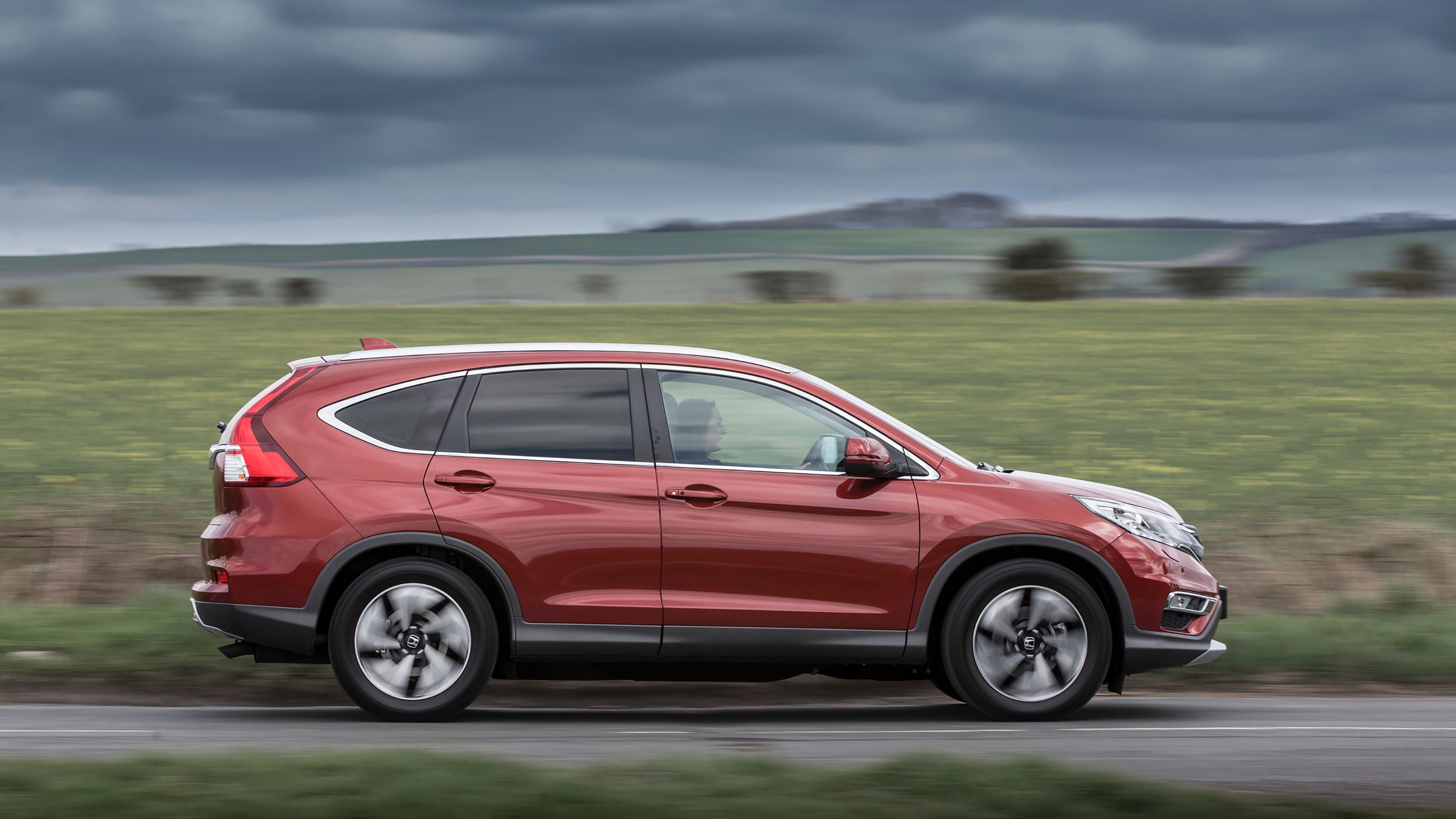 Red Honda CR-V side driving