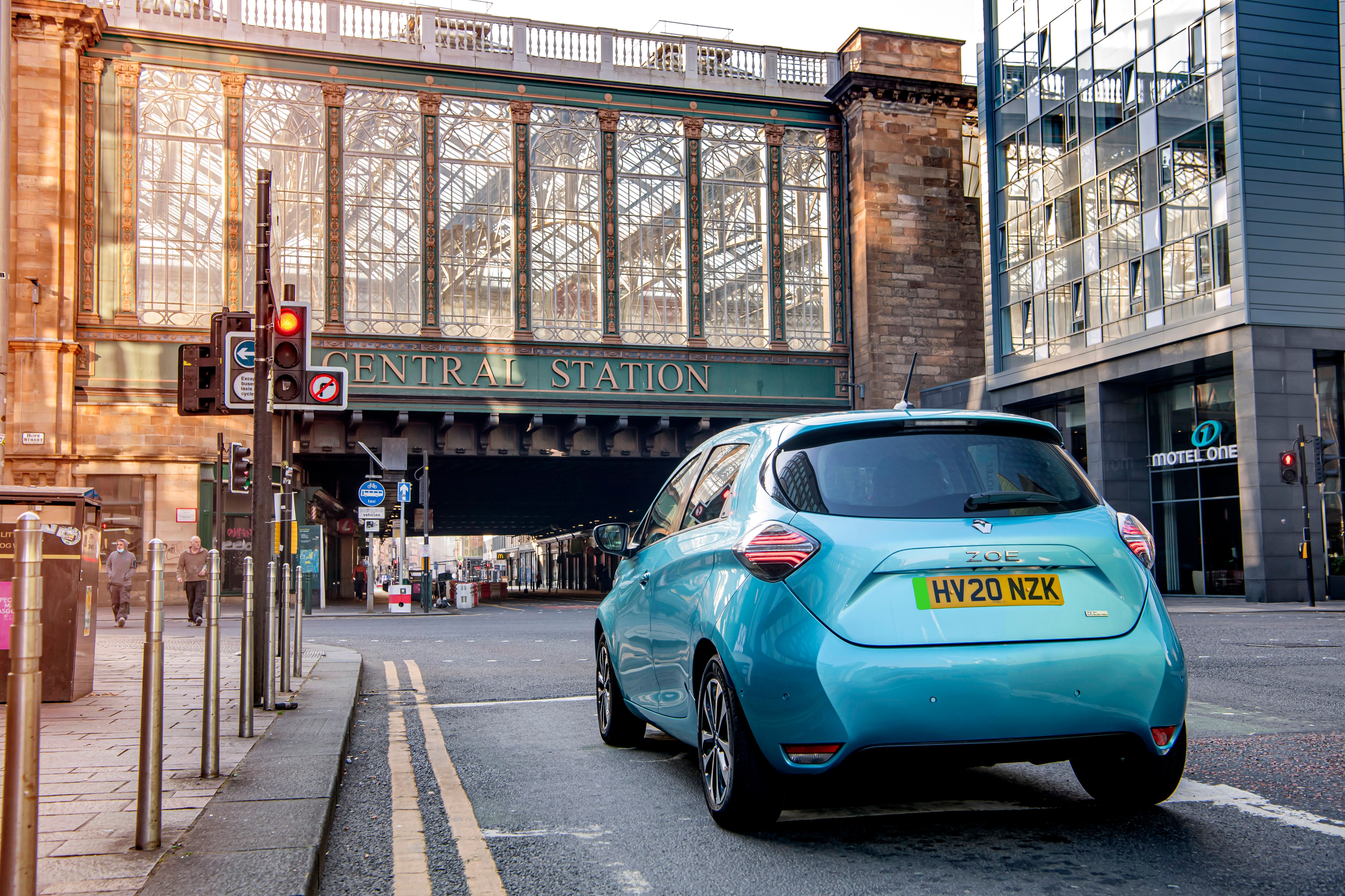 Blue Renault Zoe driving in town
