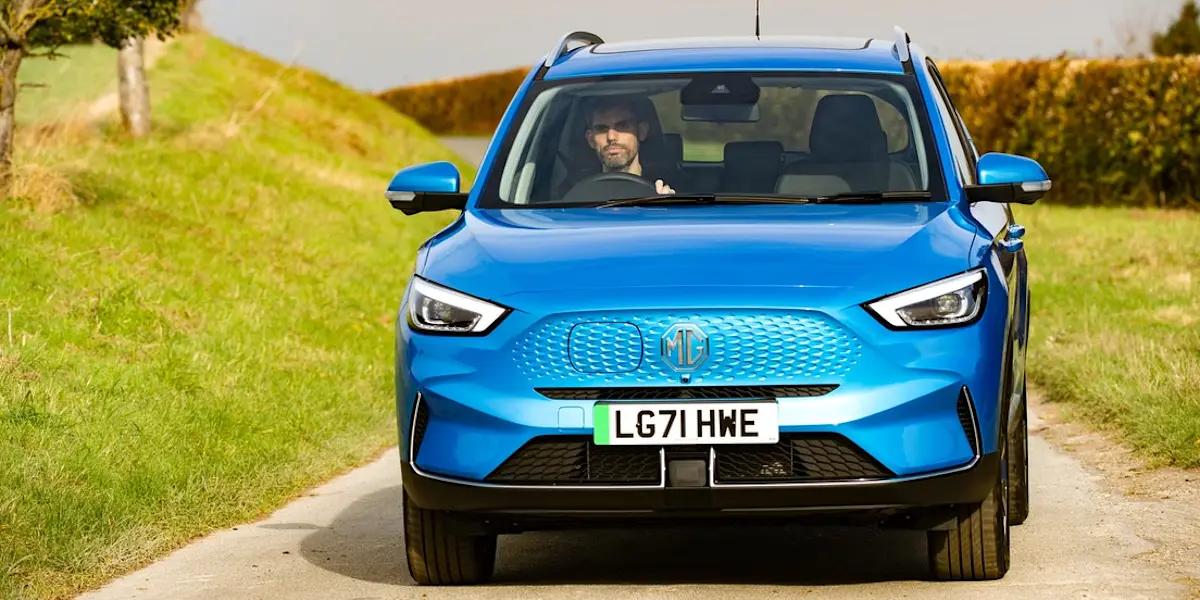 blue car in countryside road