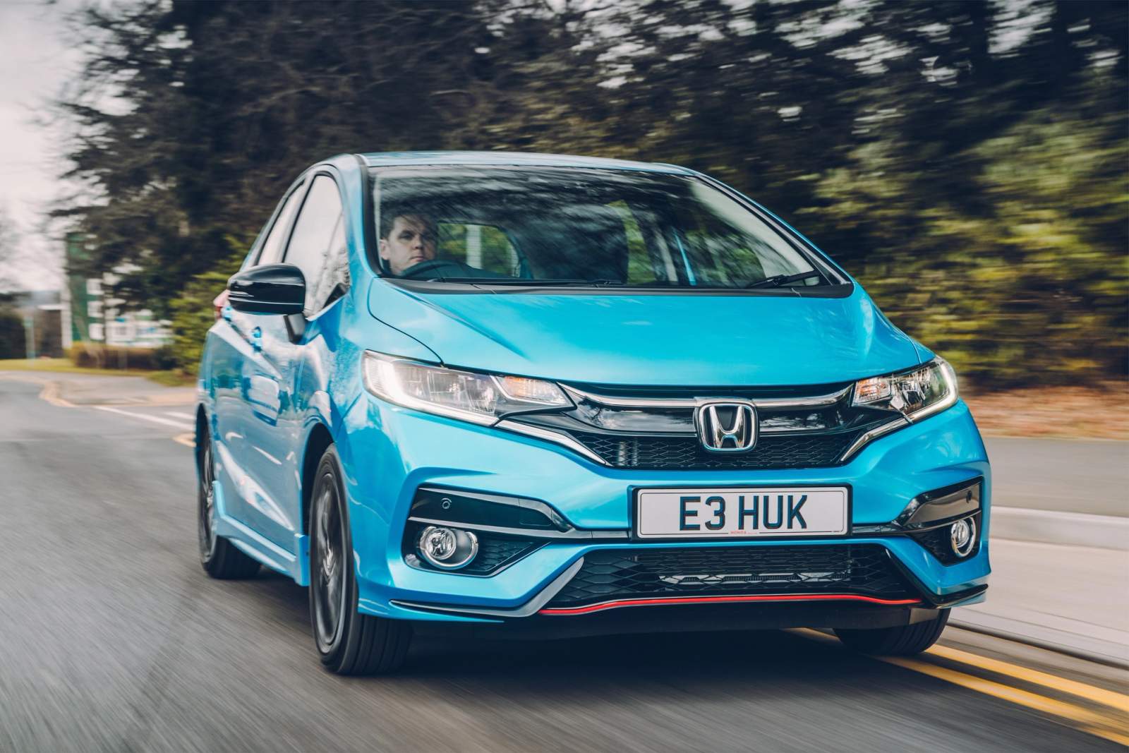 blue car on road