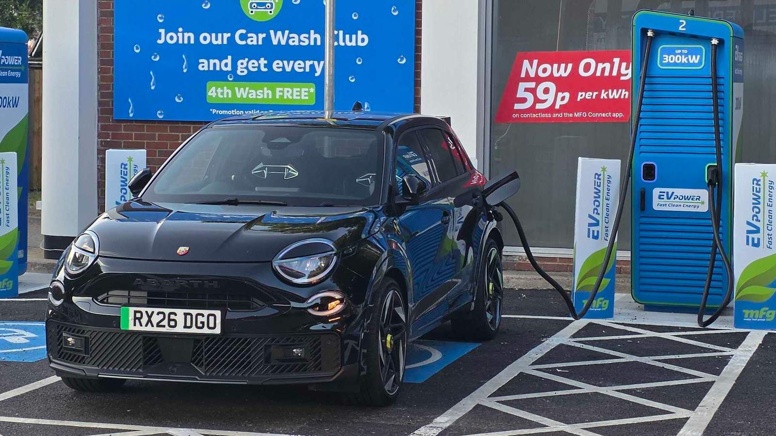 Abarth 600e charging at a public charging station