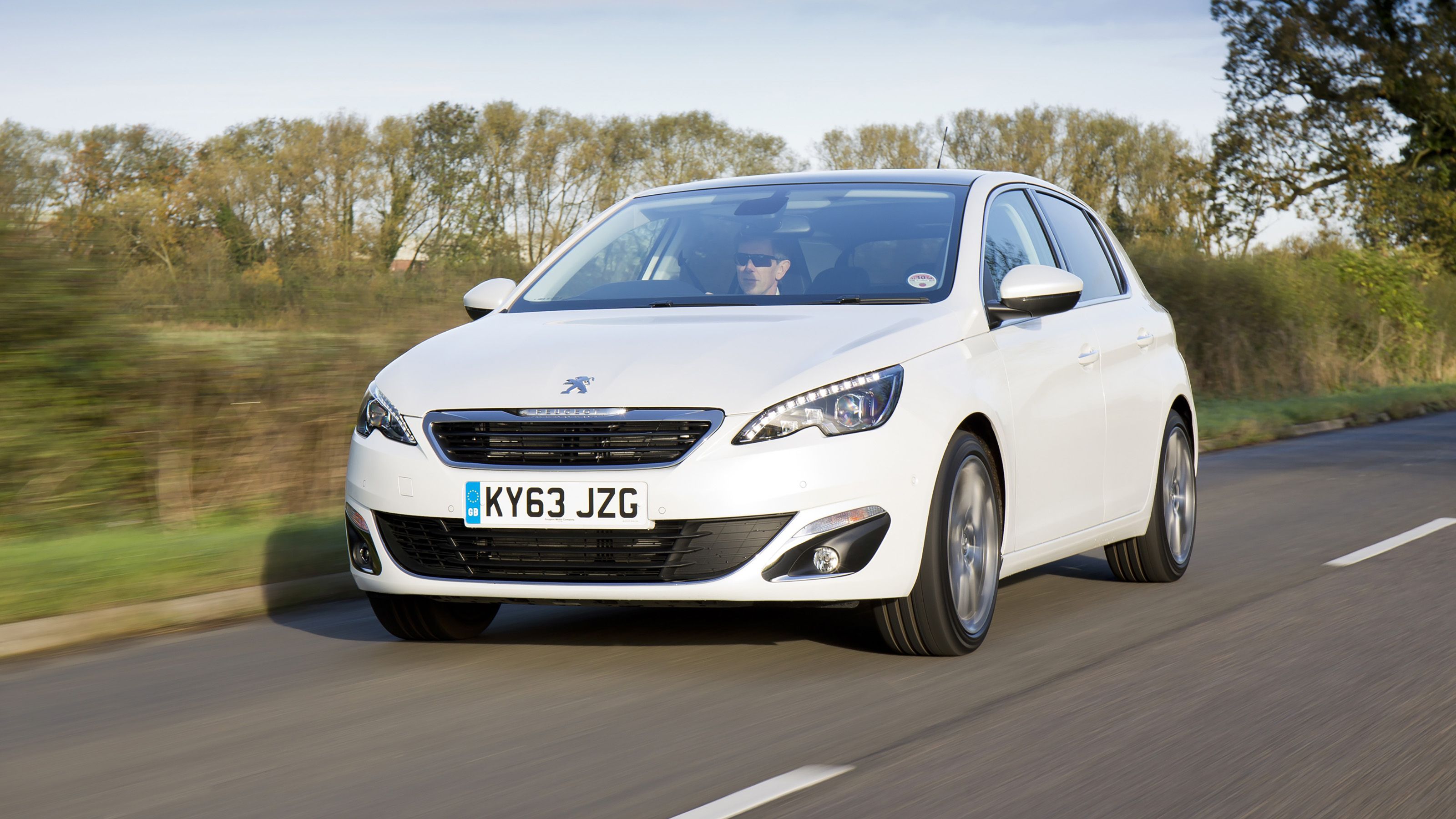 White Peugeot 308 front driving