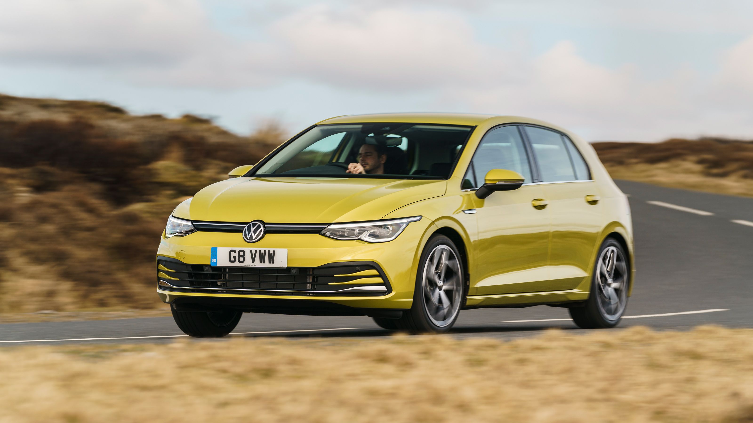 Green Volkswagen Golf front driving