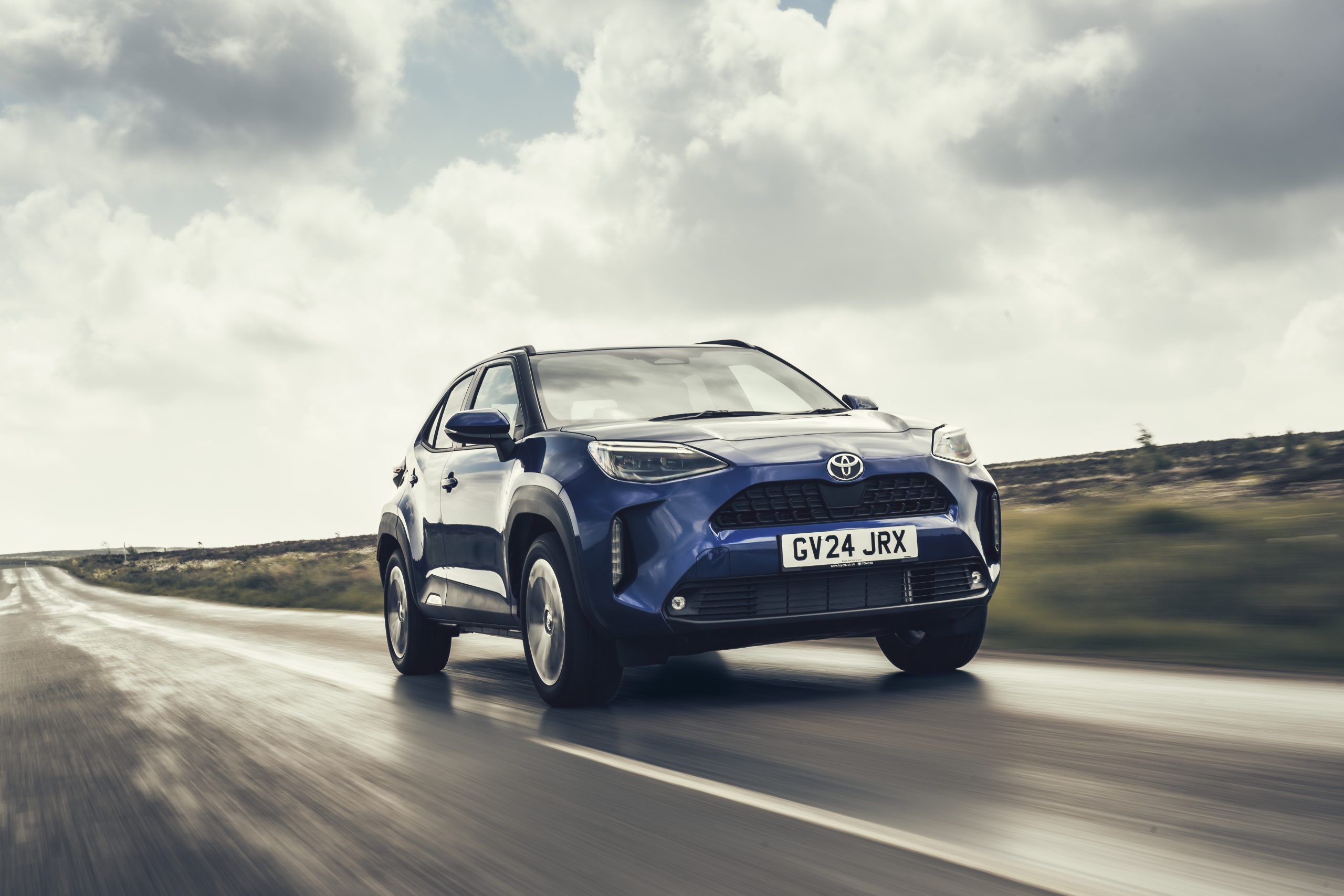 Blue Toyota Yaris Cross driving