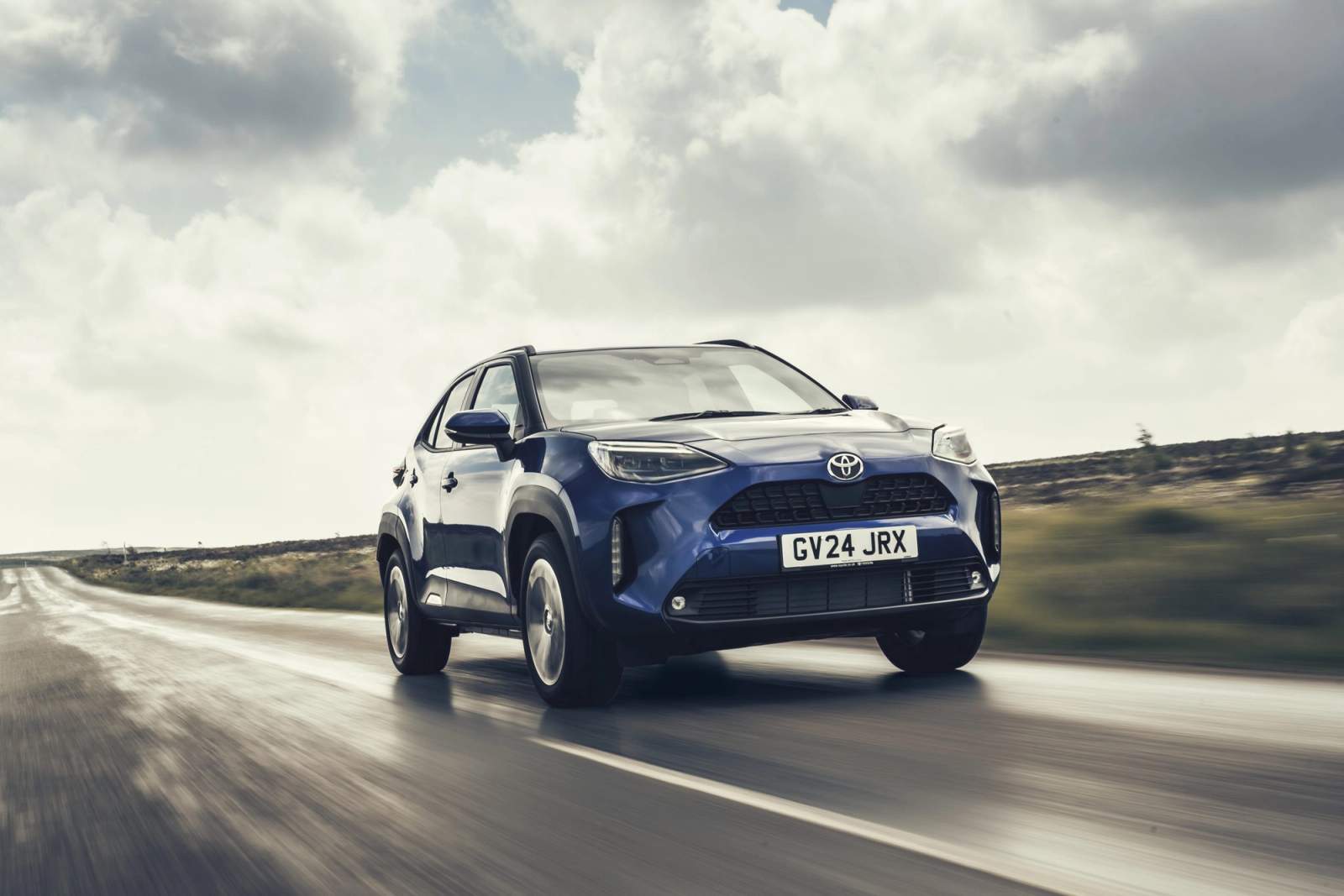 Blue Toyota Yaris Cross driving