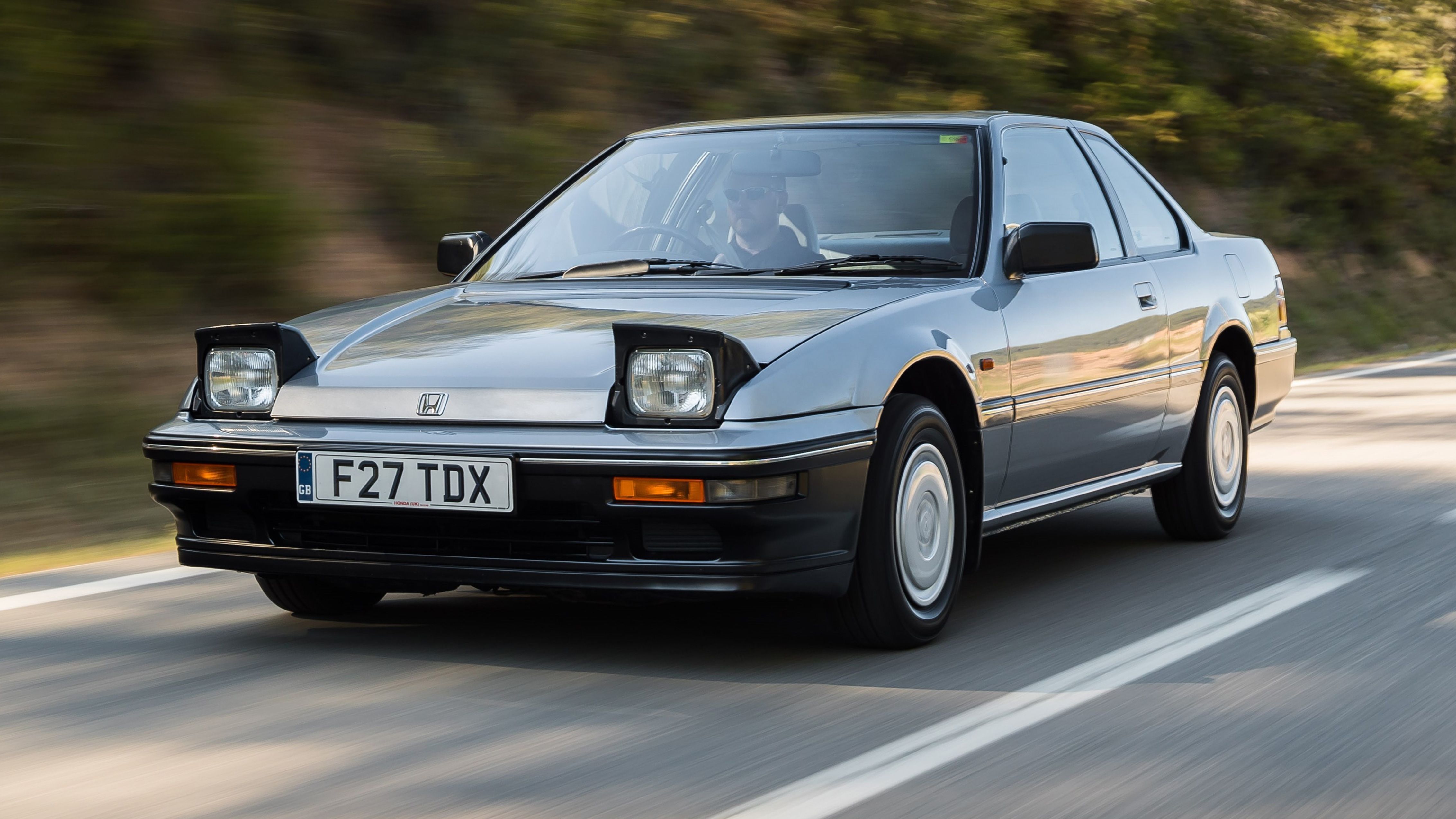 Retro Honda Prelude driving on road