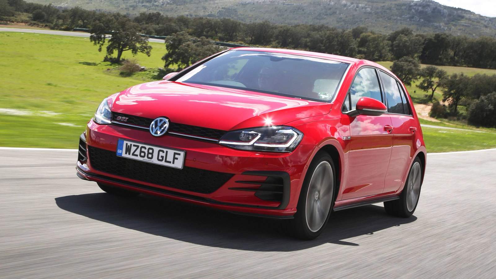Red Volkswagen Golf GTI driving