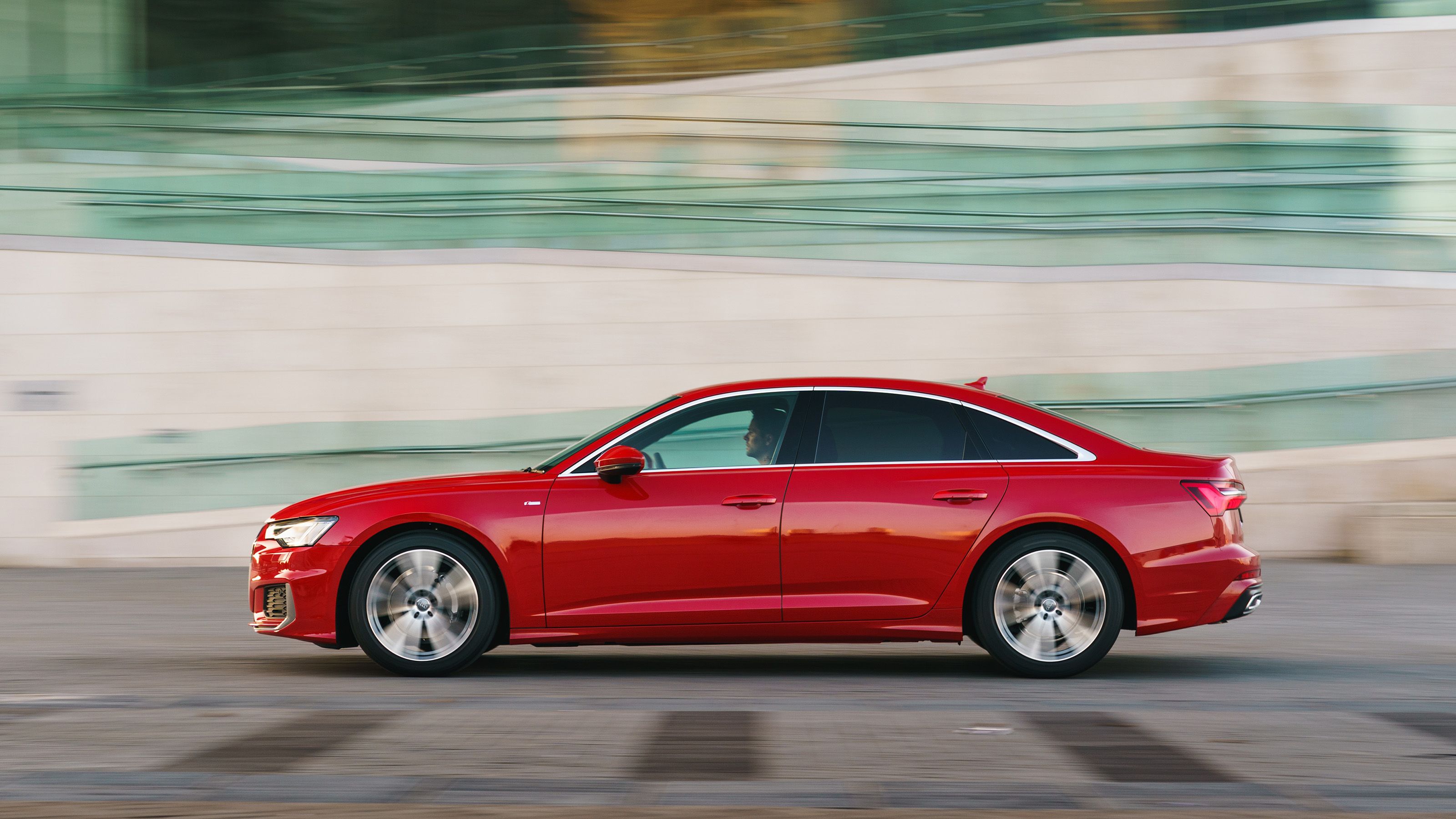 Red Audi A6 side driving