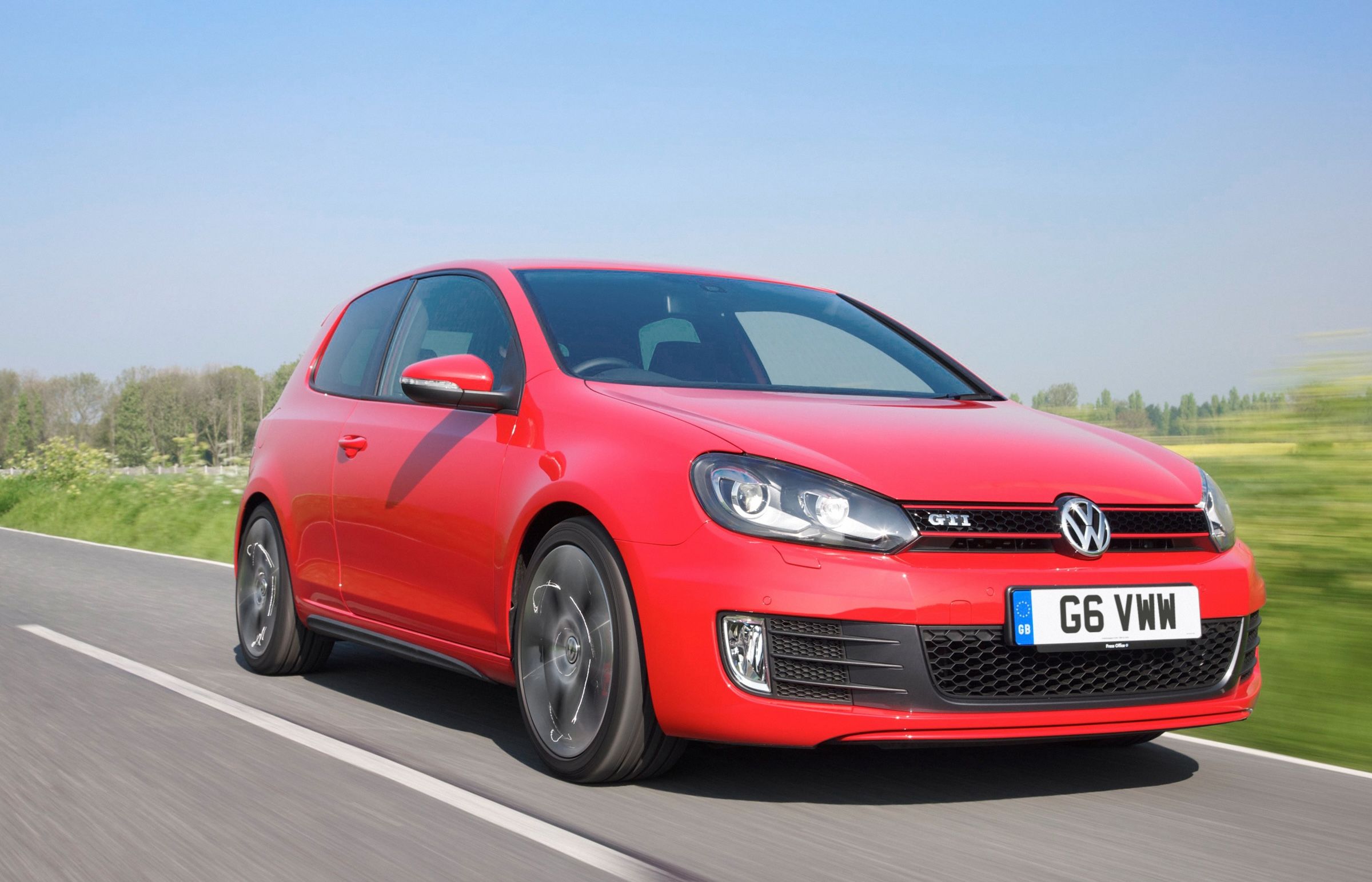 Red Volkswagen Golf GTI driving