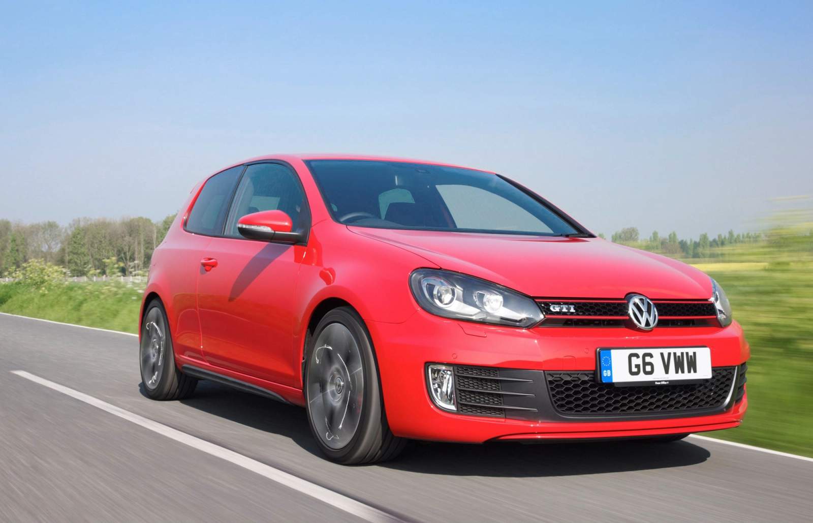 Red Volkswagen Golf GTI driving