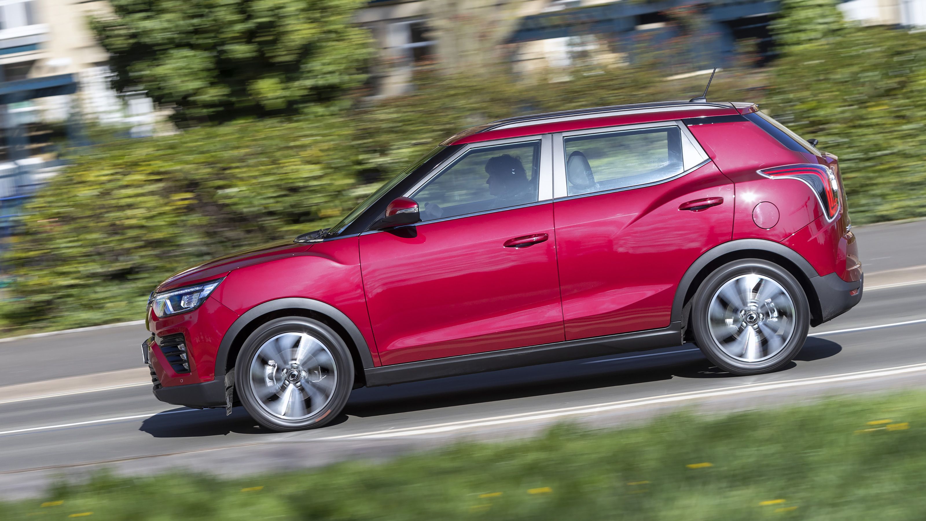 Red SsangYong Tivoli side driving