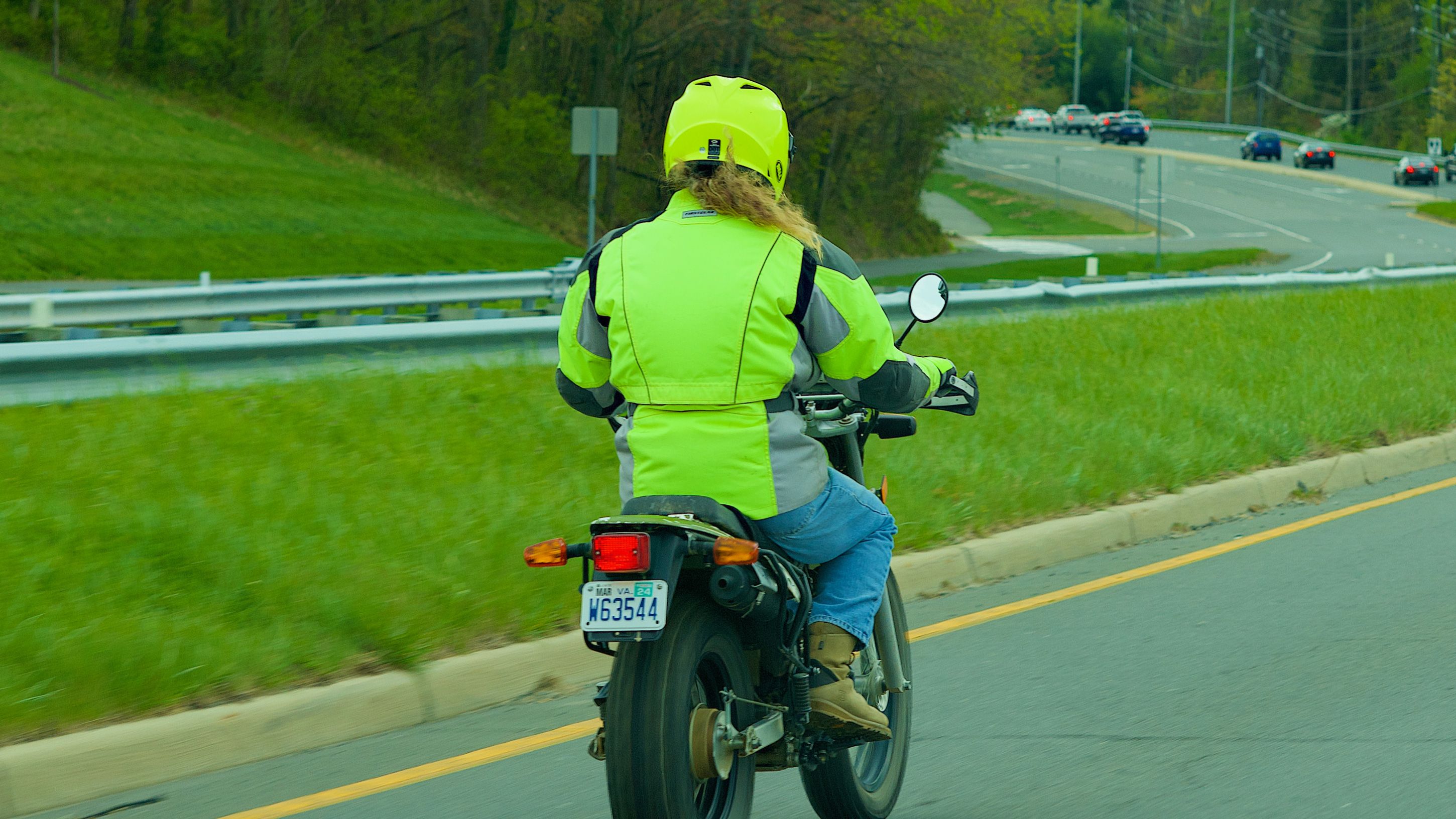 Lady riding motorbike with hi-vis on