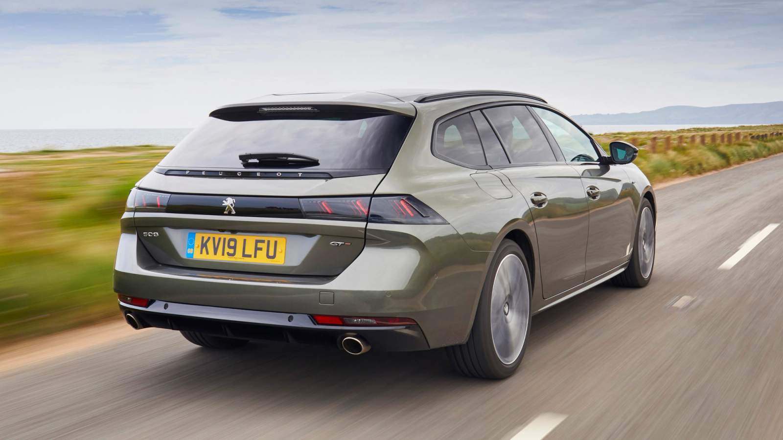 Green Peugeot 508 SW driving