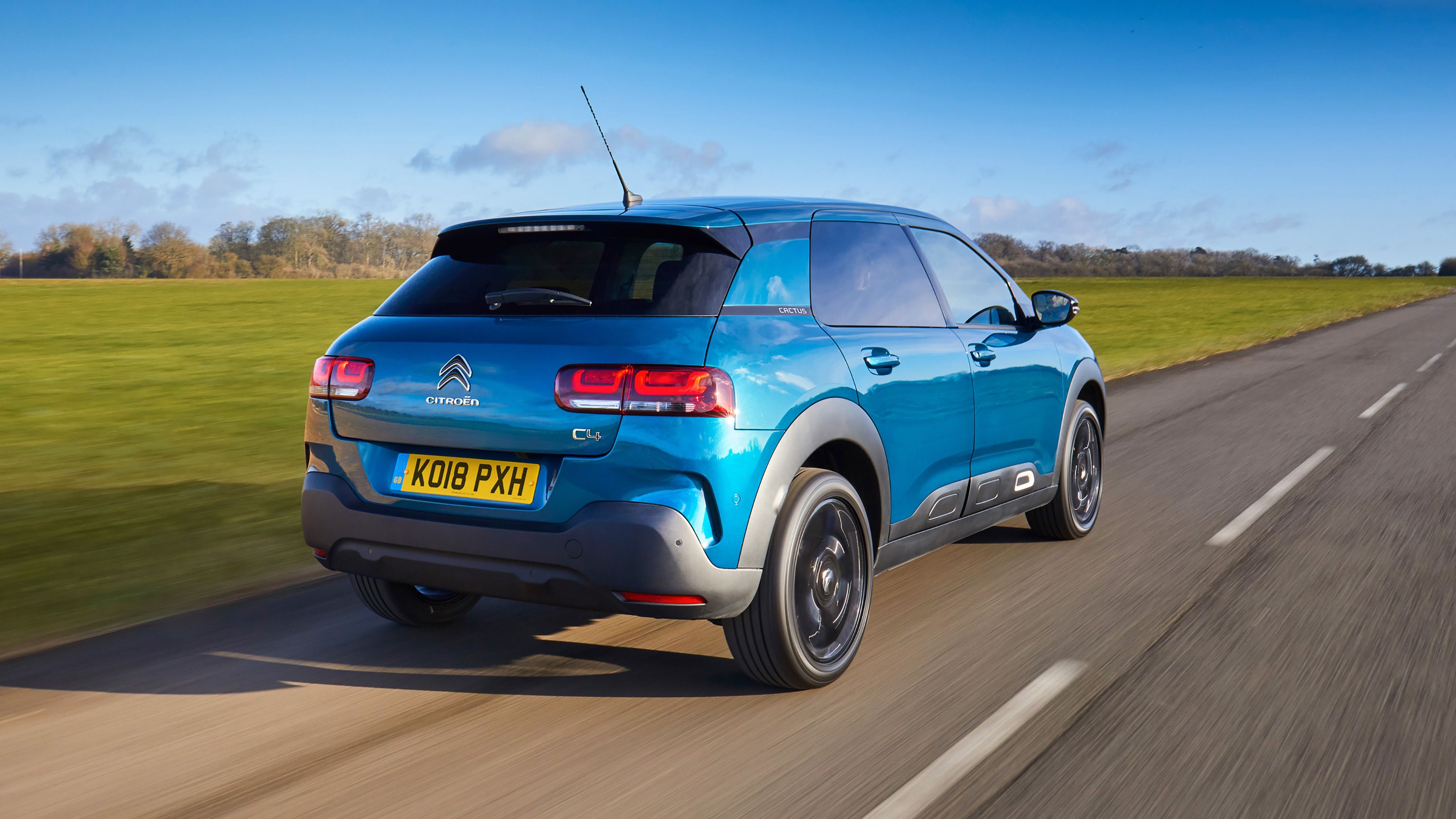 Blue Citroen C4 rear driving