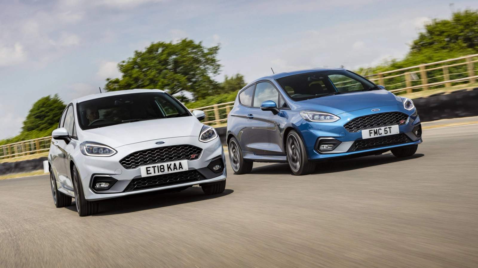 A grey and blue Ford Fiesta ST driving on a track day