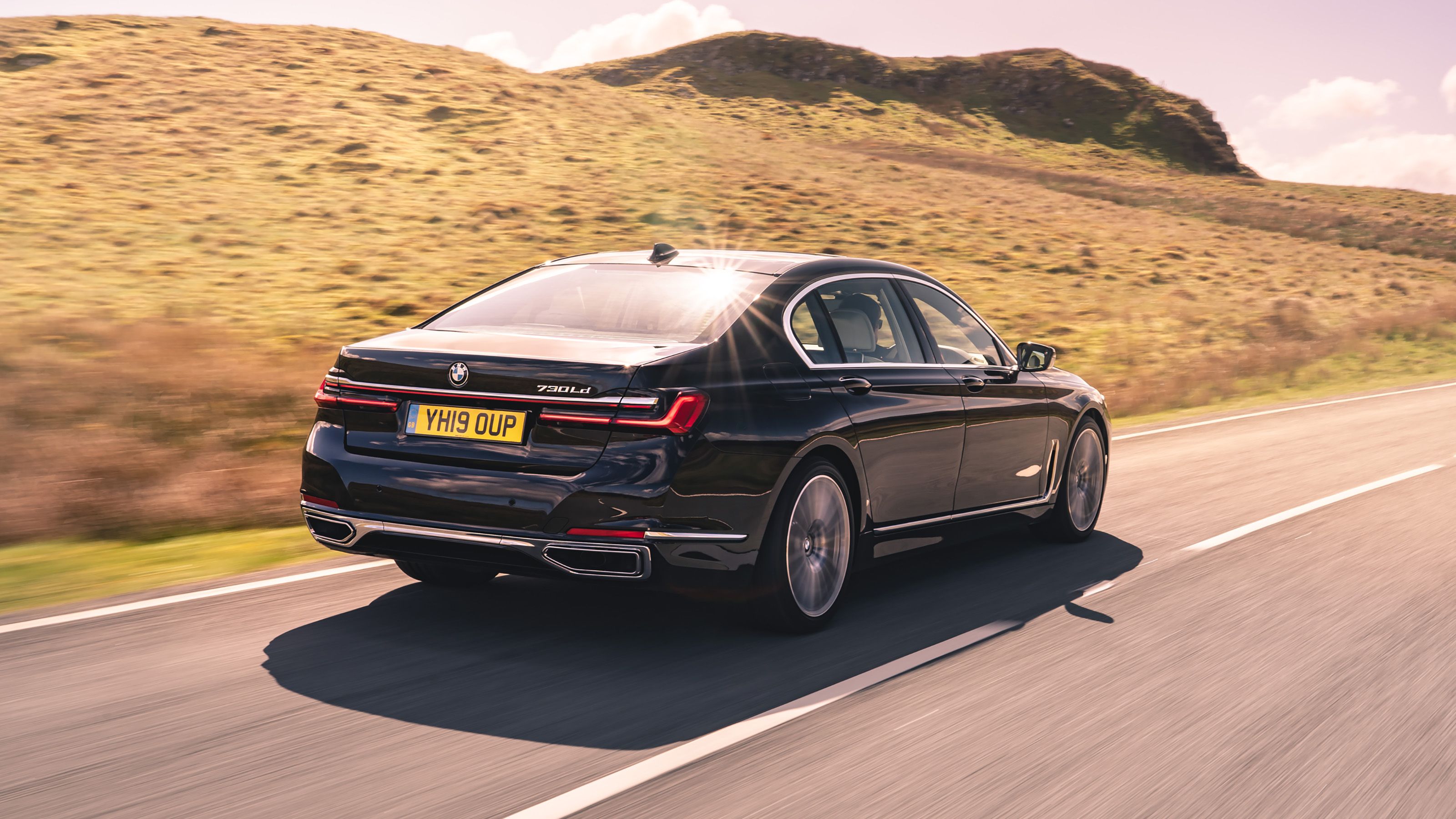 Black BMW 7 Series rear driving