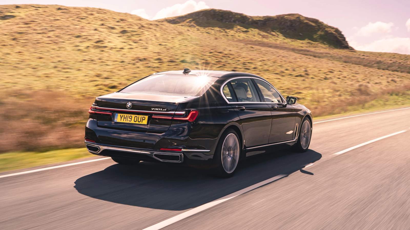 Black BMW 7 Series rear driving