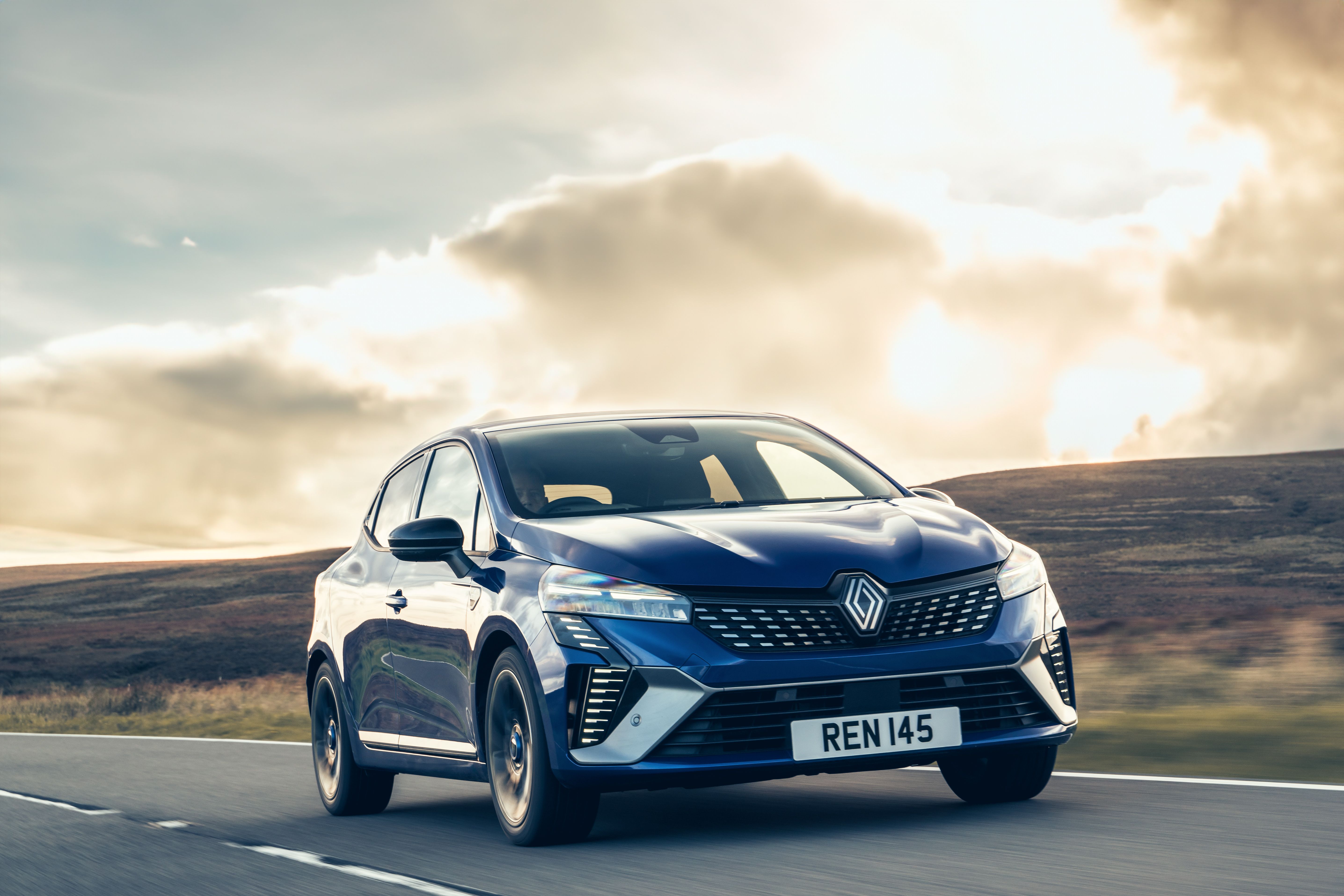 Blue Renault Clio driving