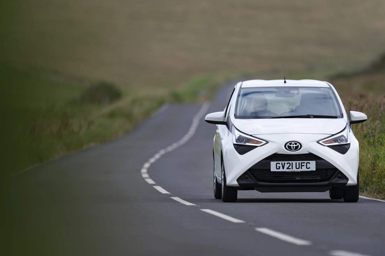 white car on road 