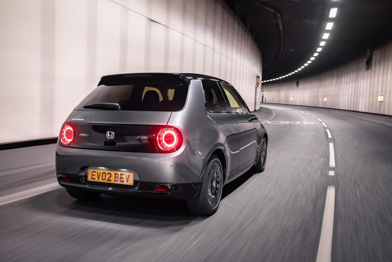 Grey Honda E rear driving