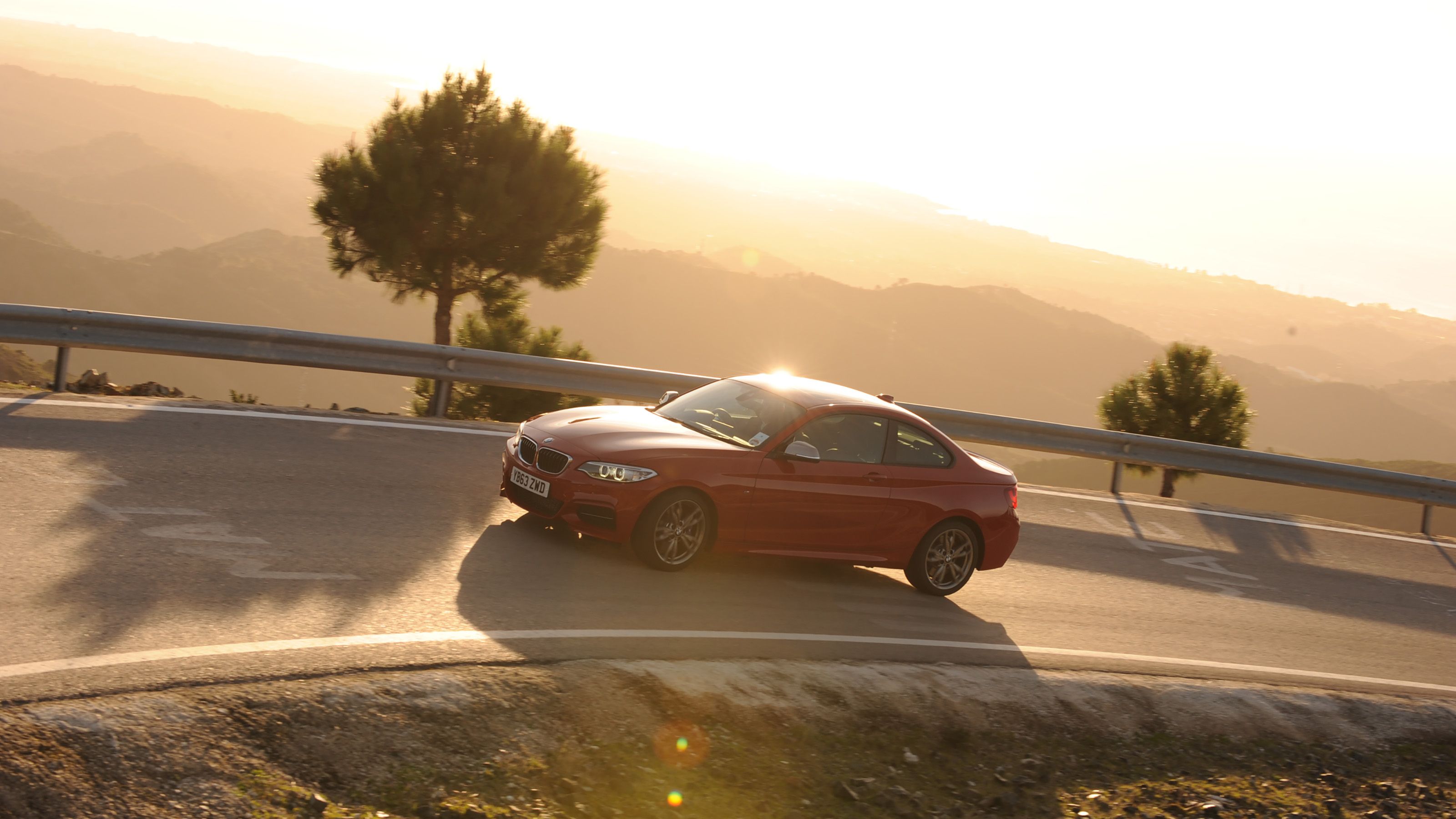 Red BMW M235i driving