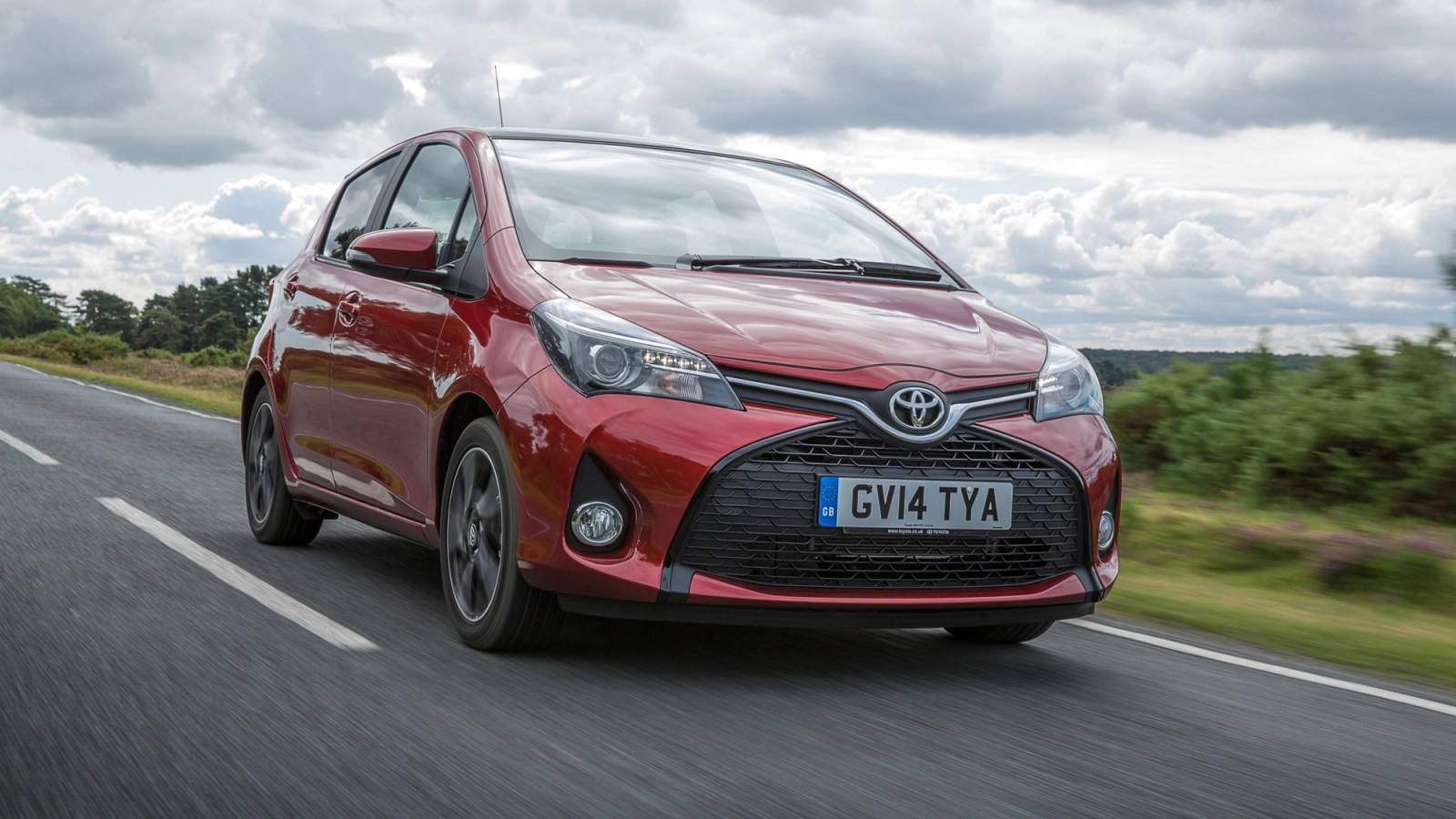 Red Toyota Yaris driving