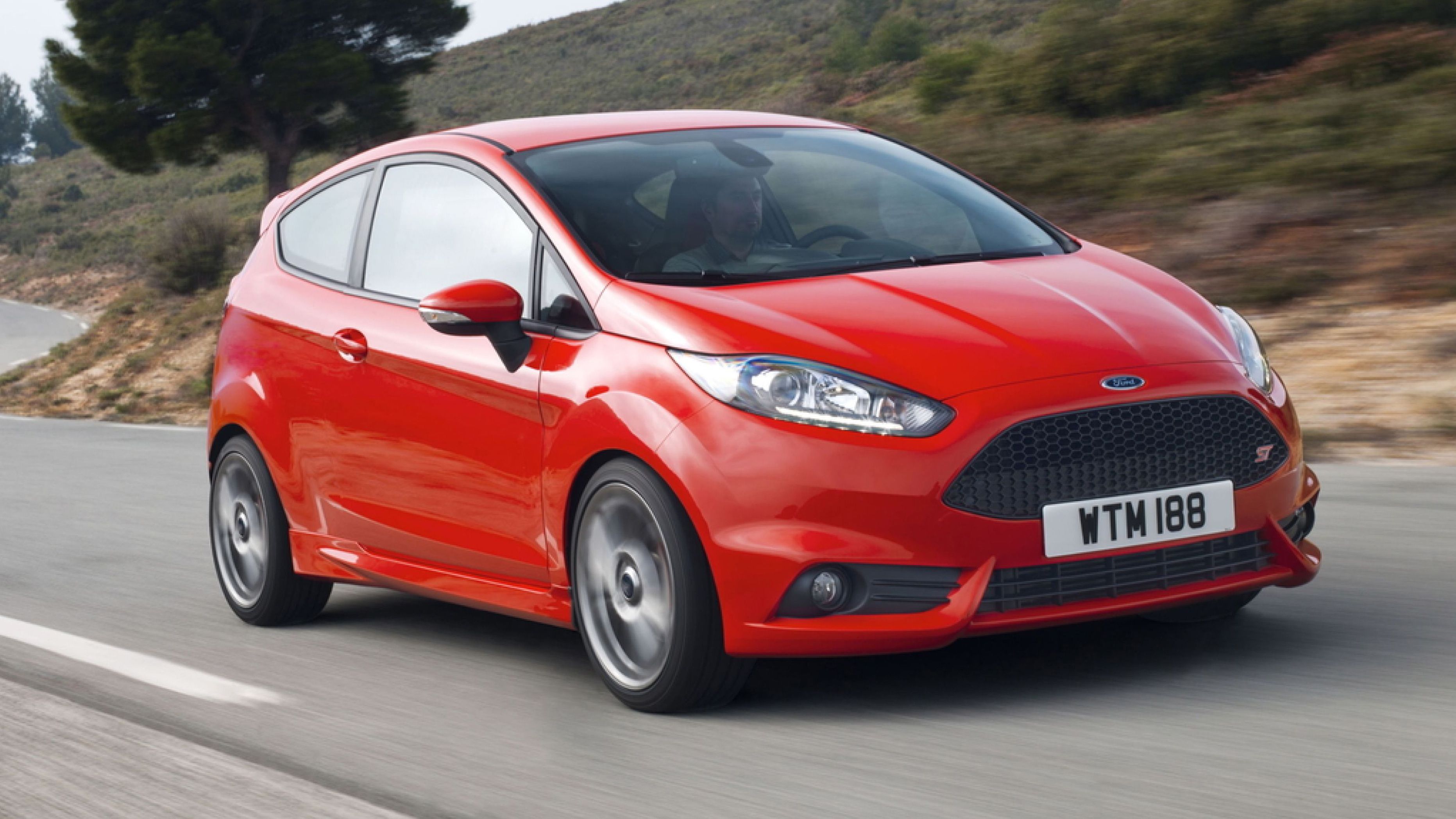 Red Ford Fiesta ST driving on the road