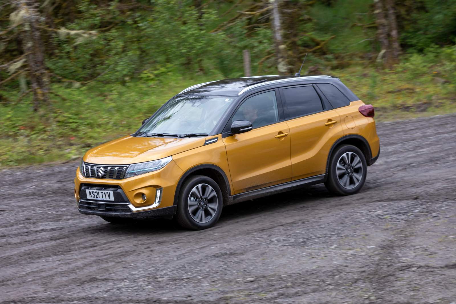 Gold Suzuki Vitara driving