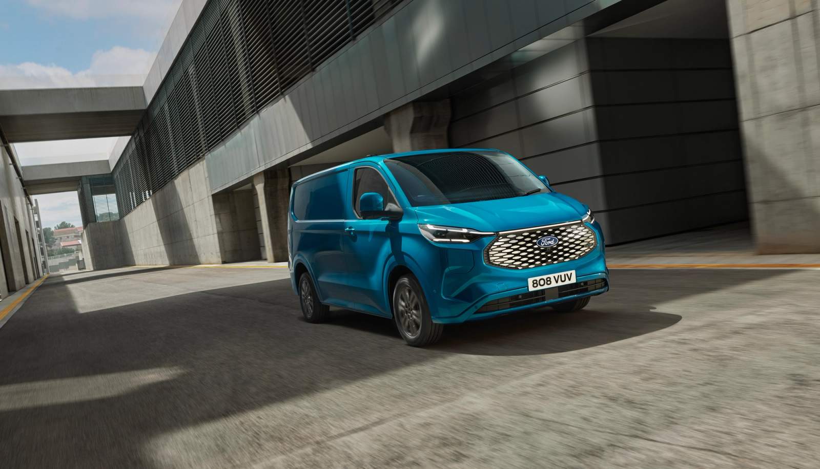 Blue Ford E-Transit Custom driving
