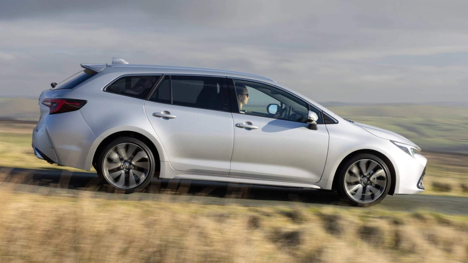 Silver Toyota Corolla Touring Sports driving in the countryside